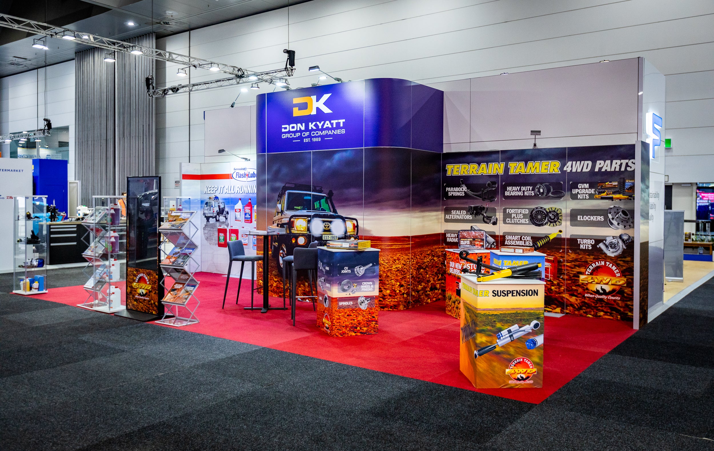 Exhibition booth with branding and product displays at a trade show.