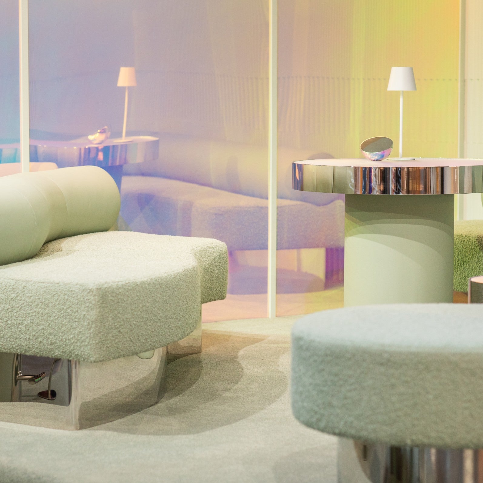 Modern interior with a round green chair and a table with books, illuminated by soft lighting. Our Zeon furniture in our Melbourne Showroom.