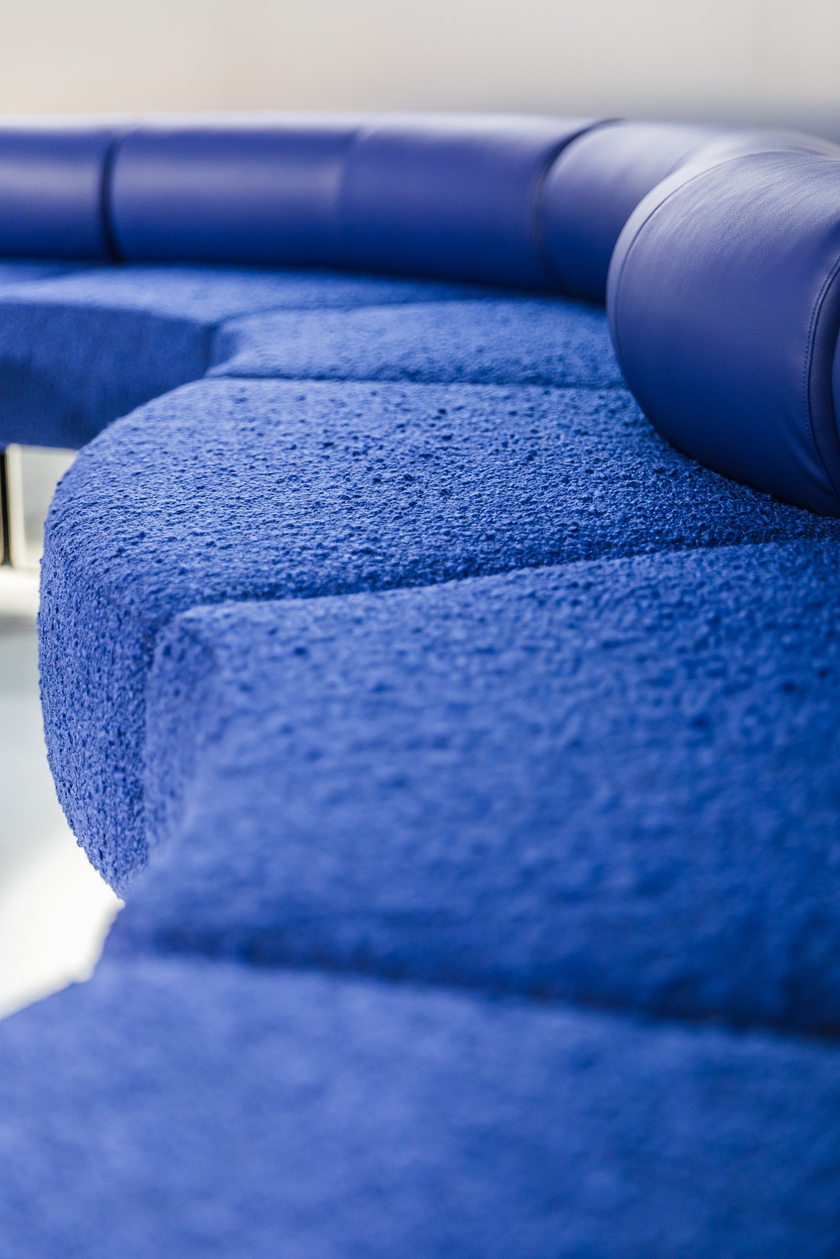Close-up of a blue textured sofa with a blurred background