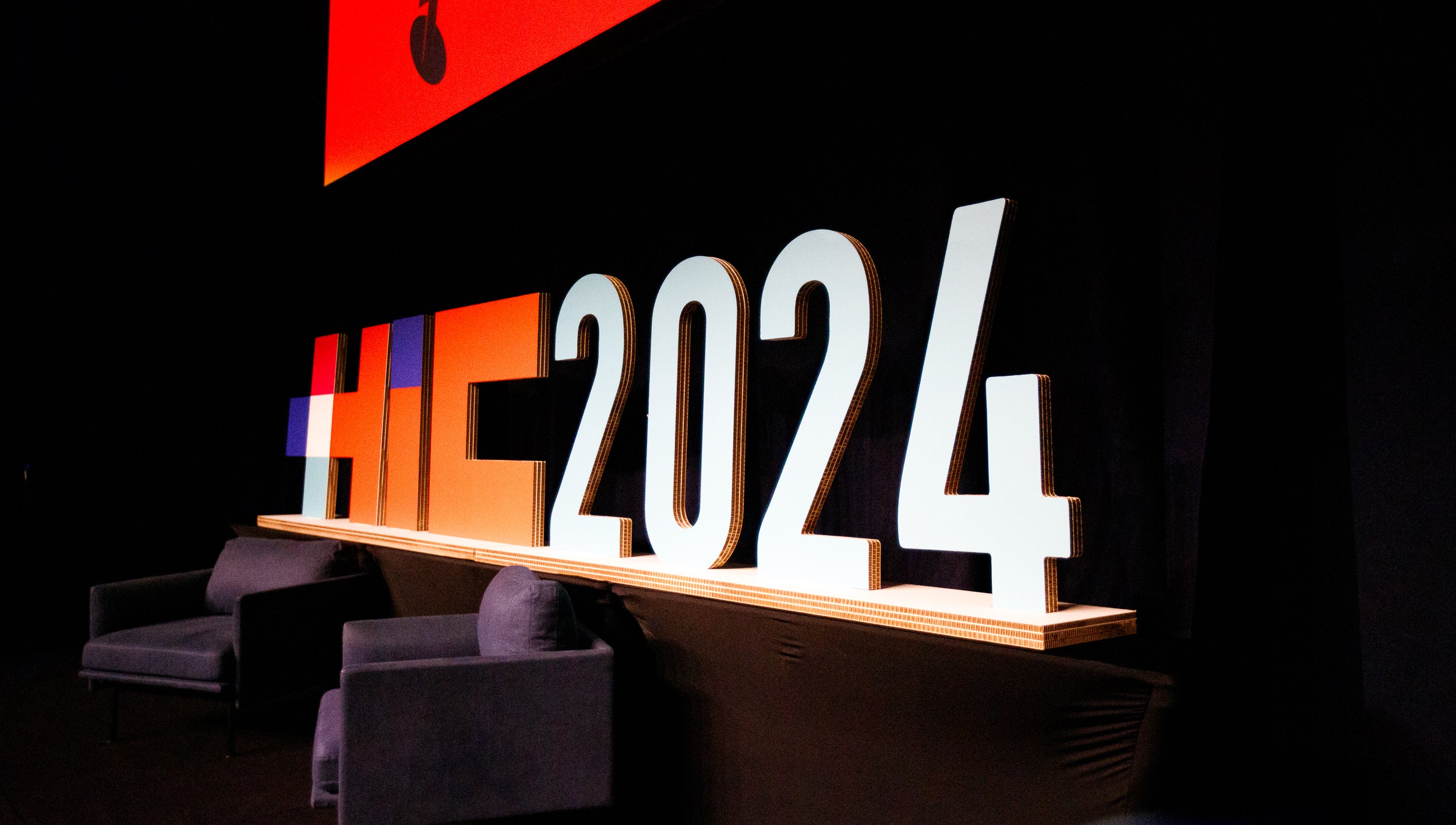 Decorative cardboard sign with '2024' on a black background