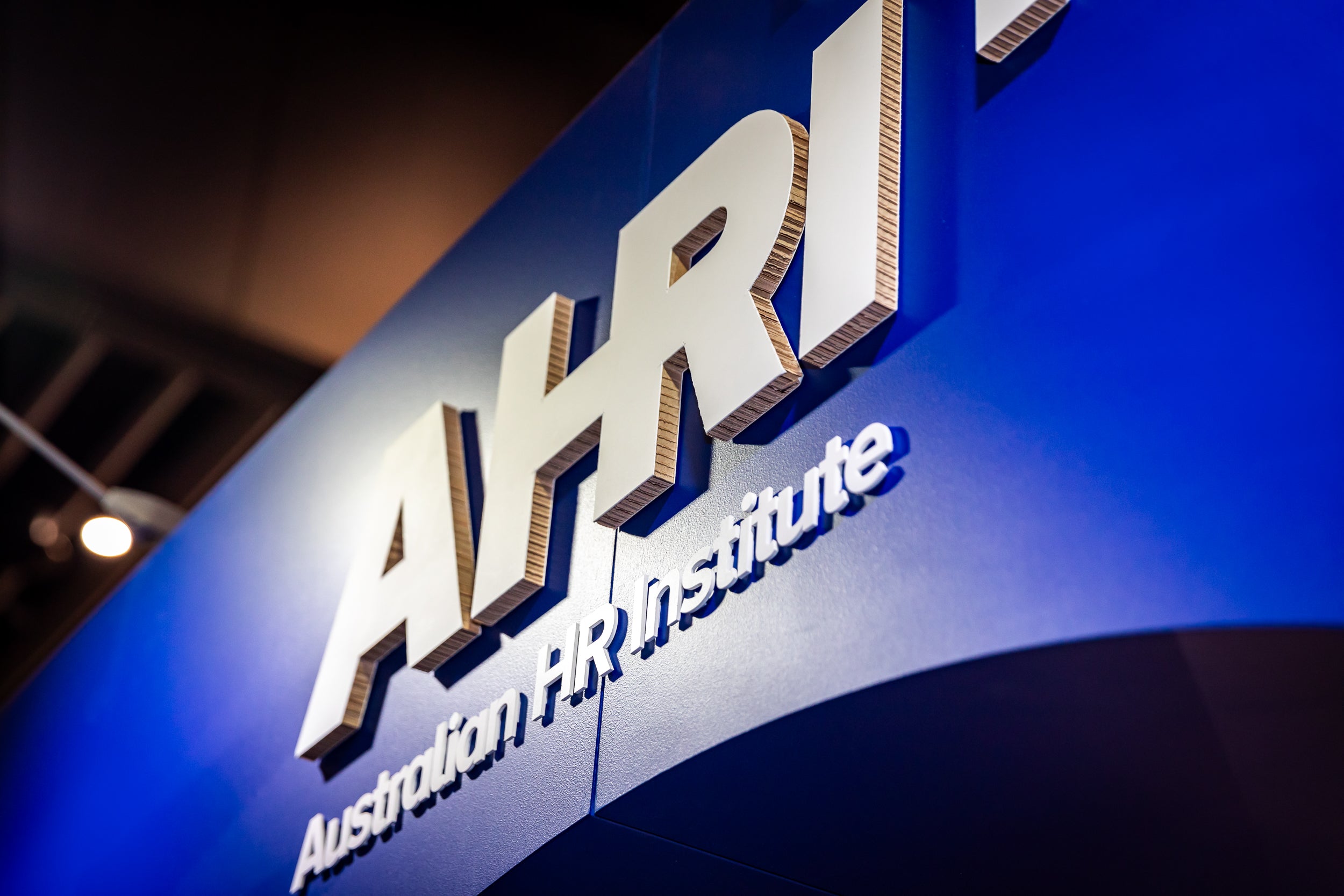 Logo of the Australian HR Institute on a blue background, made from cardboard