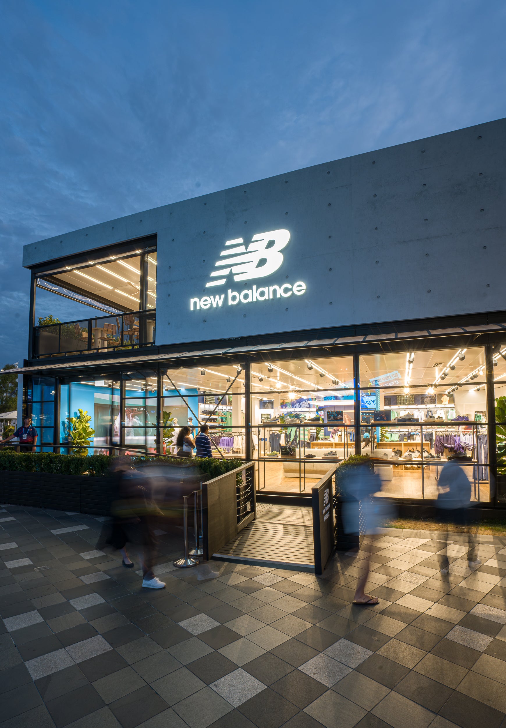 New Balance marquee exterior with illuminated sign at night