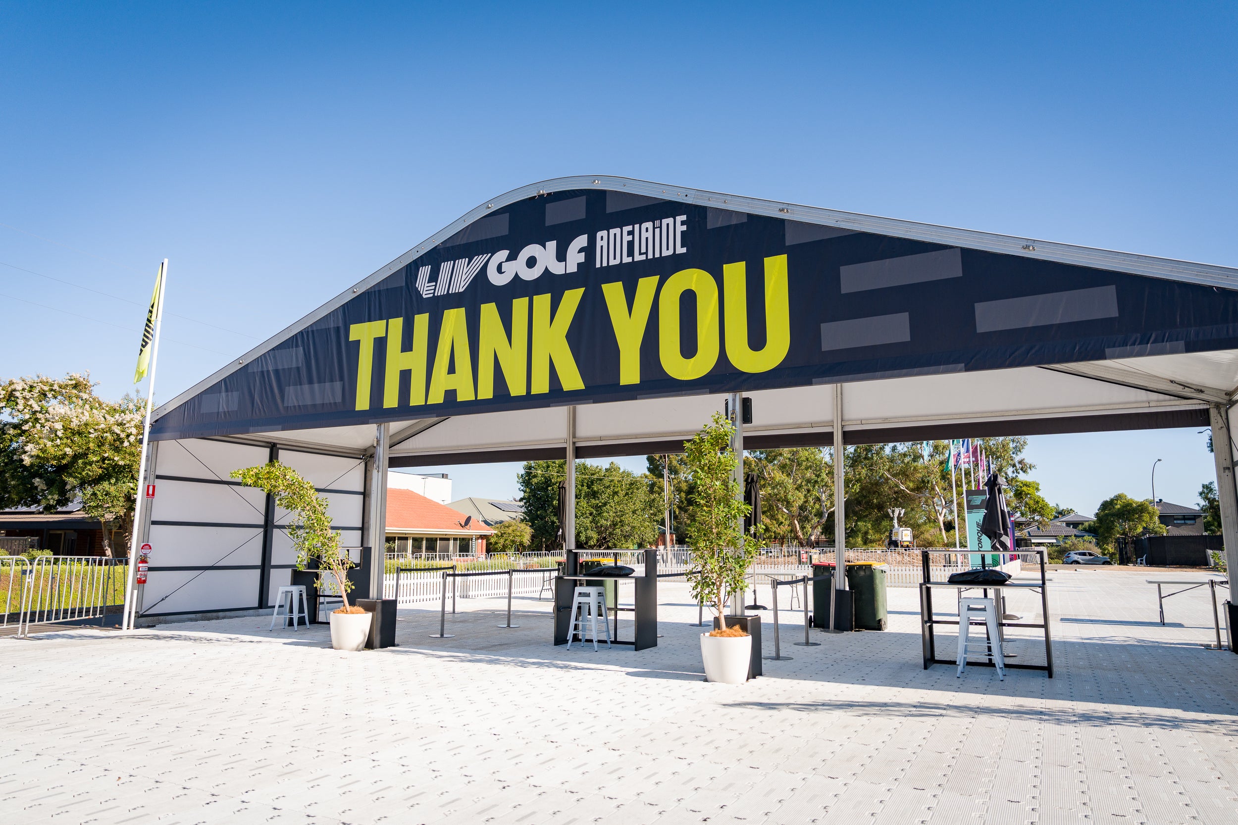 Large outdoor marquee with 'LIV Golf Adelaide' branding and 'THANK YOU' message.