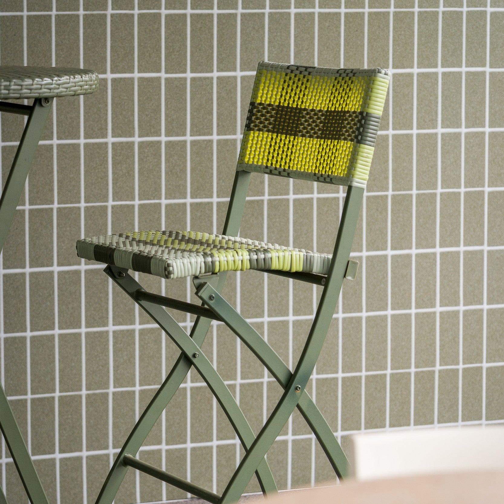 Green Cleo lattice-back chairs arranged in a casual setting onsite at Liv Golf in Adelaide