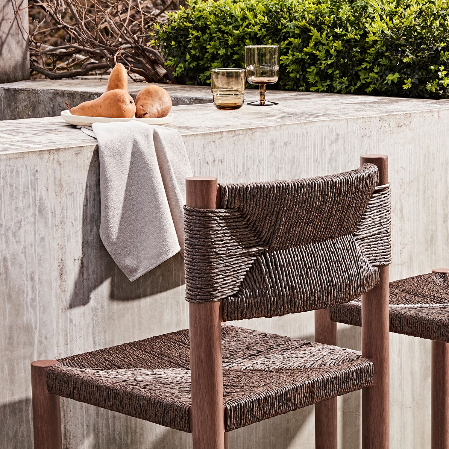 Woven chair at an outdoor table with a neutral setting