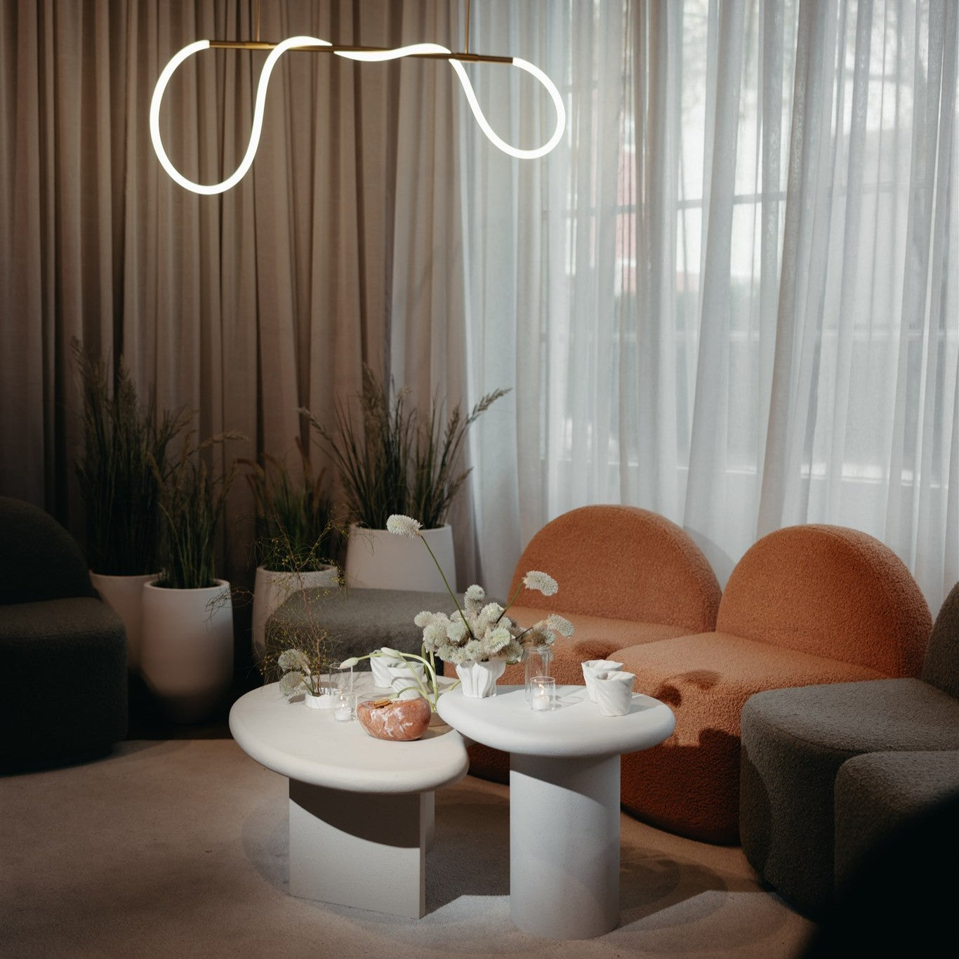 Modern seating area with a stylish lamp, Harper sofa, and Lava coffee table.