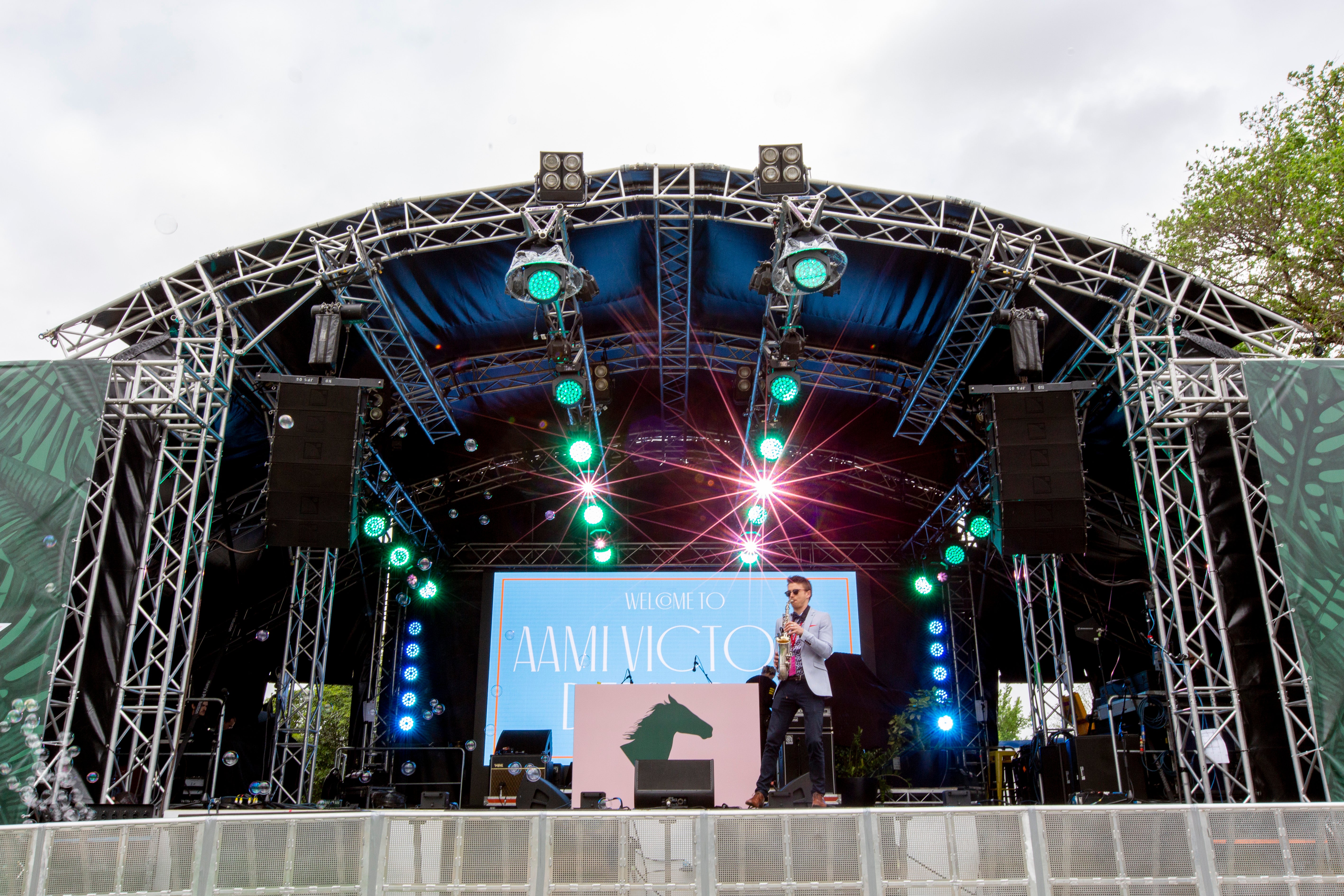 Stage setup with a performer on stage at a Spring Racing Carnival event
