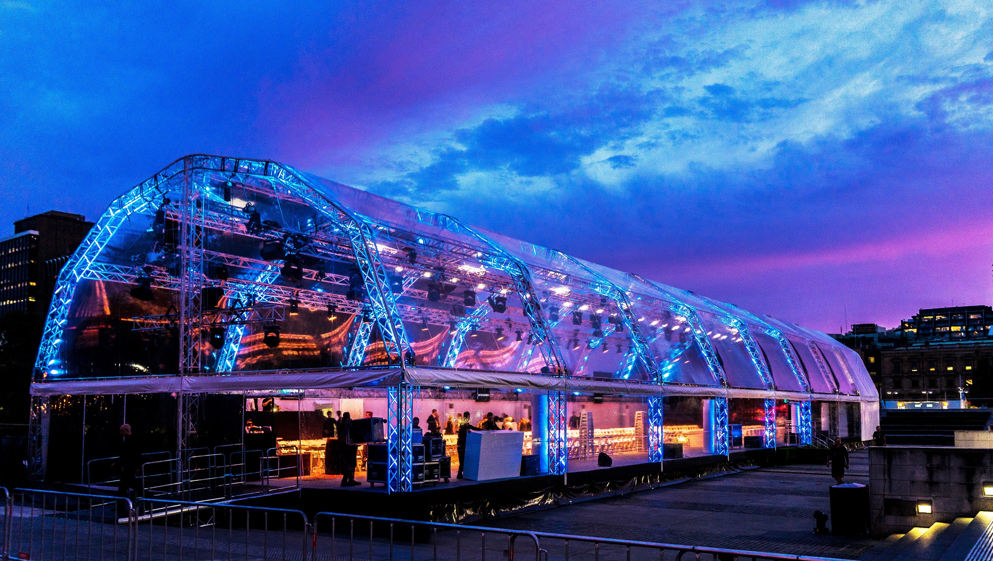 A Harry The Hirer Marquee with blue lighting against a purple sky