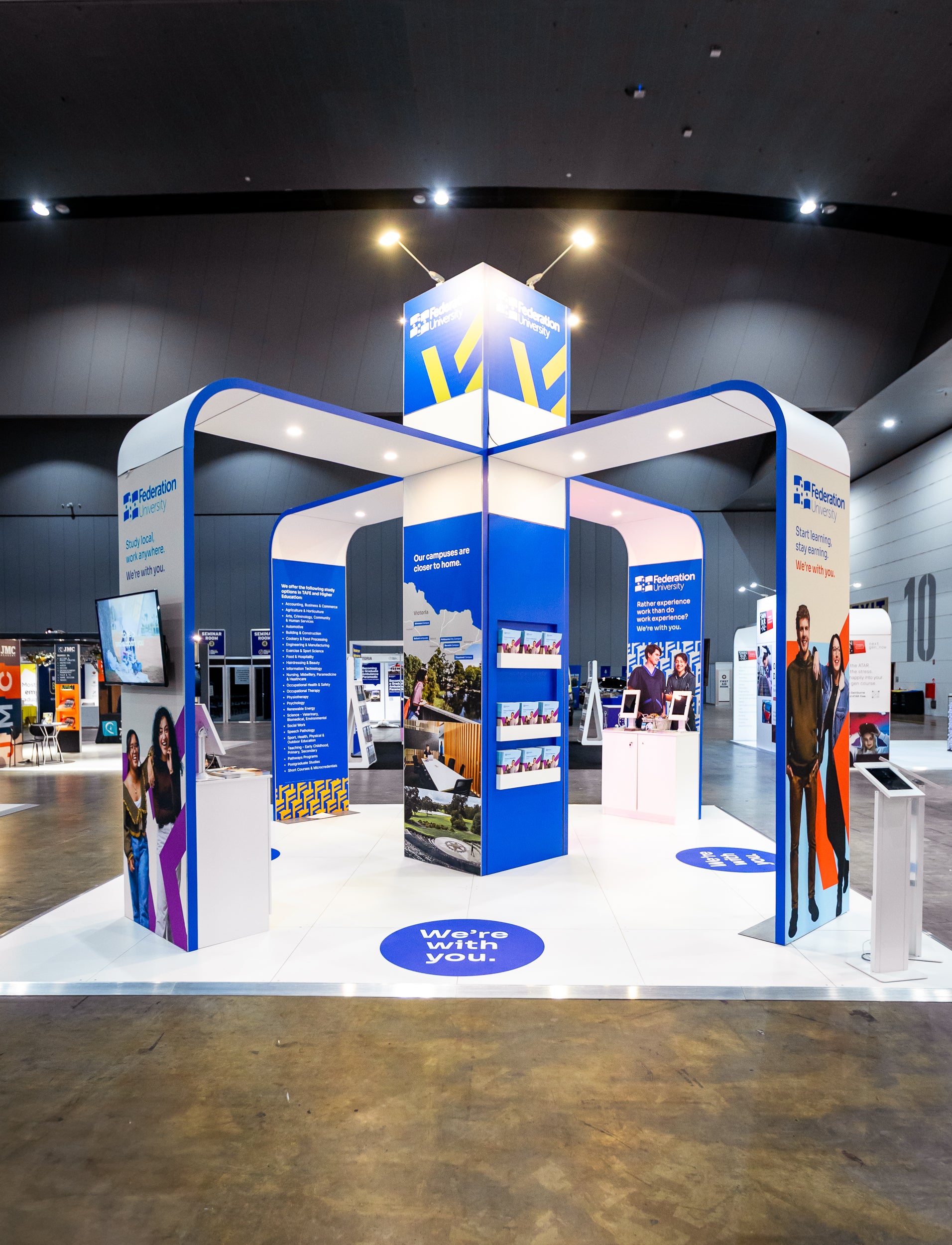 Exhibition stand with blue and white design in a large indoor space