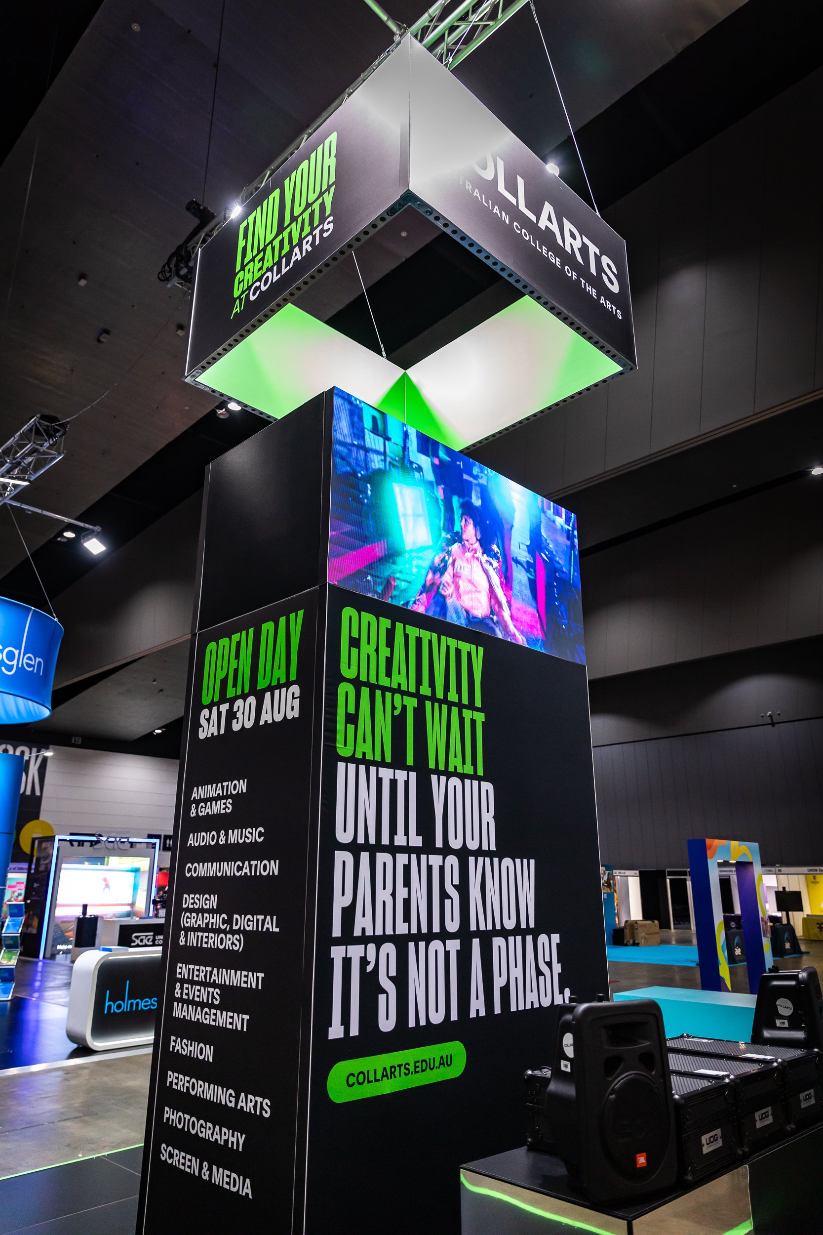 Promotional stand with digital display and text about a 'Collarts' expo stand.