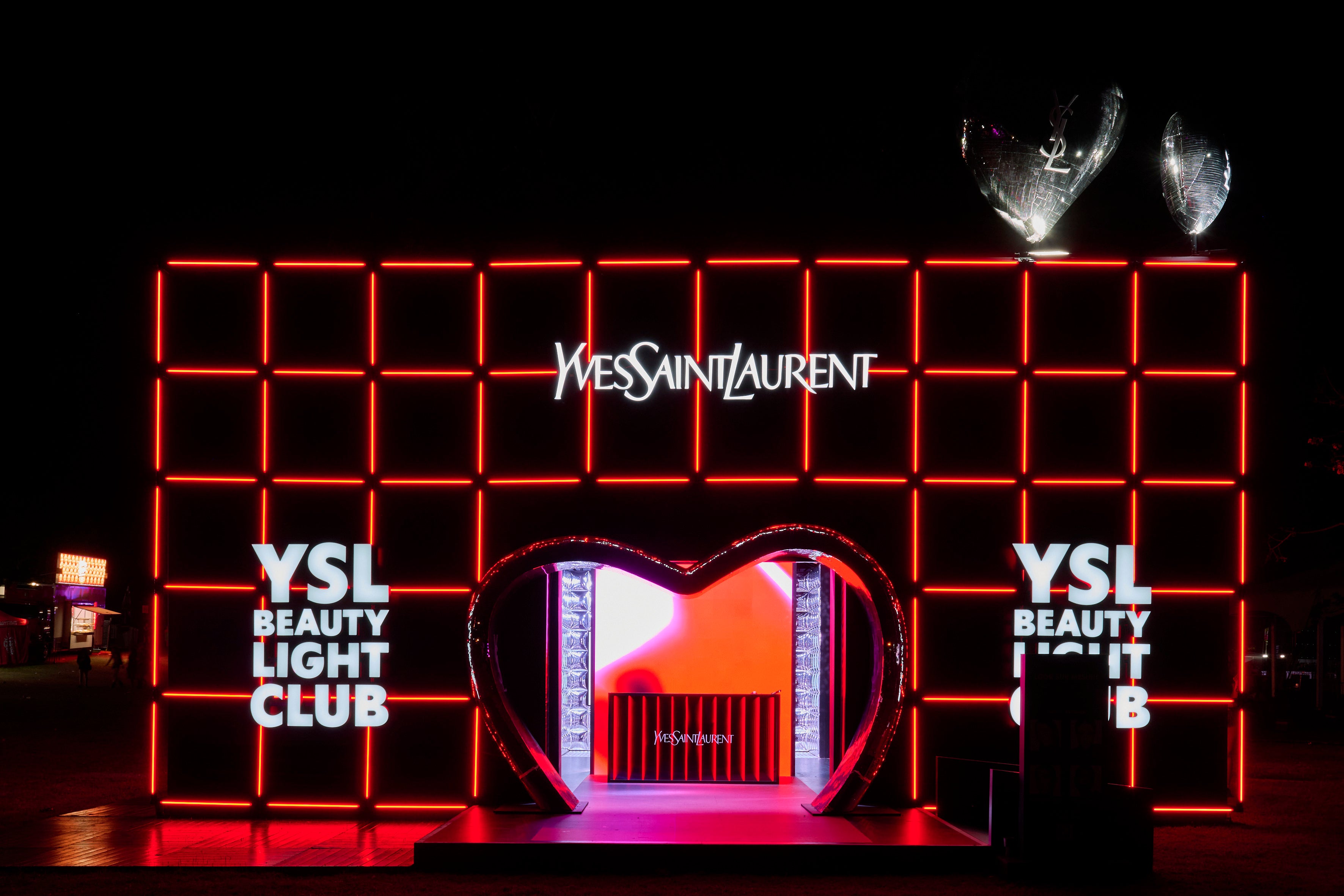 YSL Beauty Light Club display with illuminated YSL branding