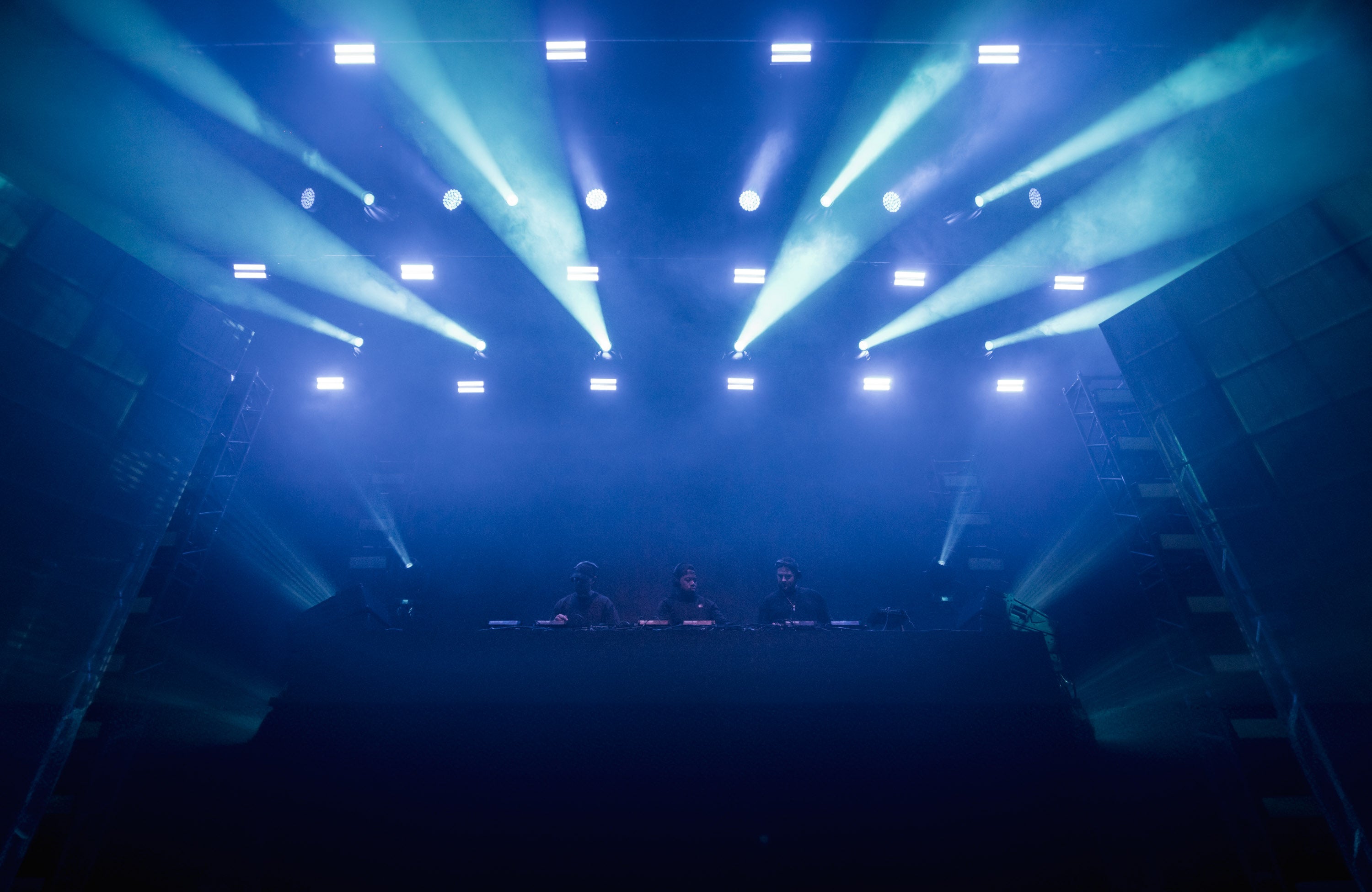 Stage with blue and green lights in a dark auditorium