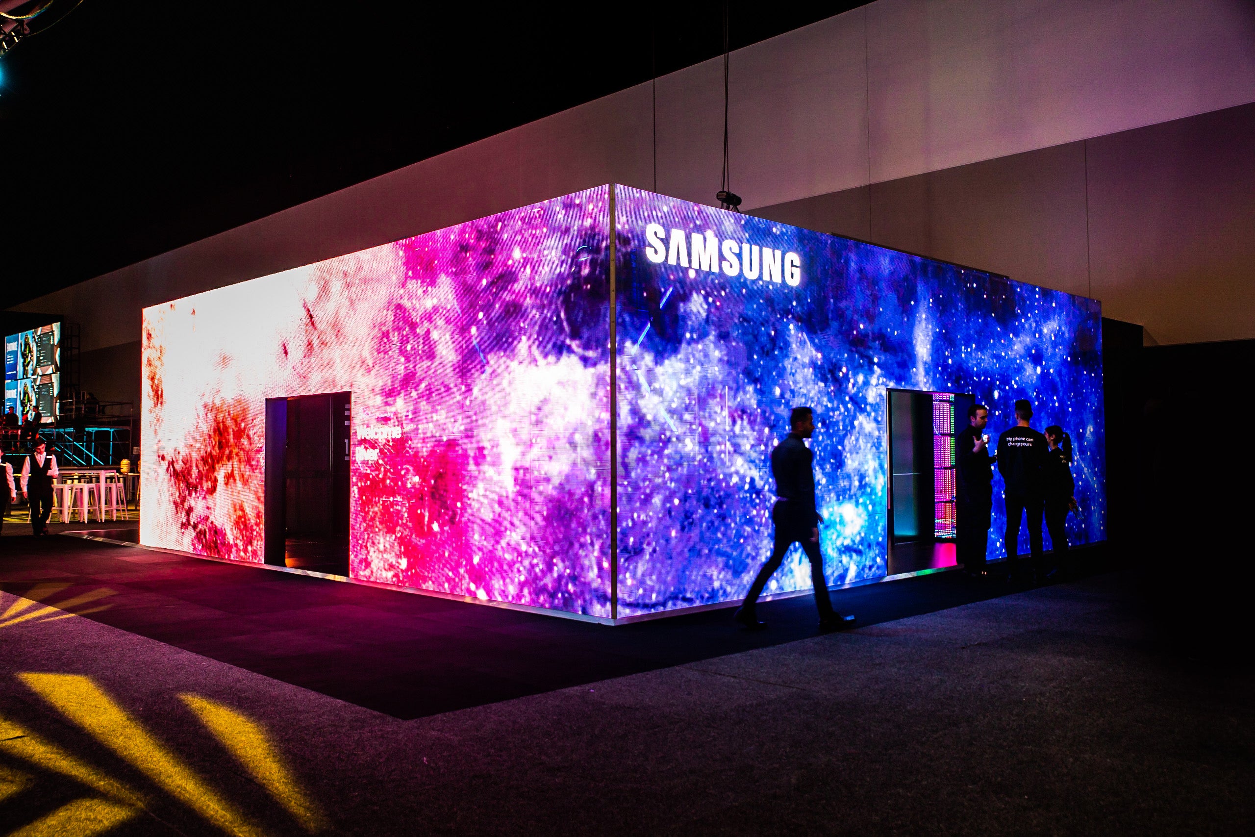Samsung exhibition stand display with colorful LED wall in a dark setting