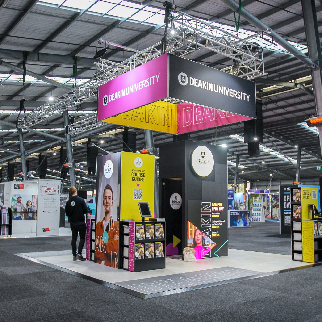 Deakin University exhibition stand with colorful branding in a large indoor venue.