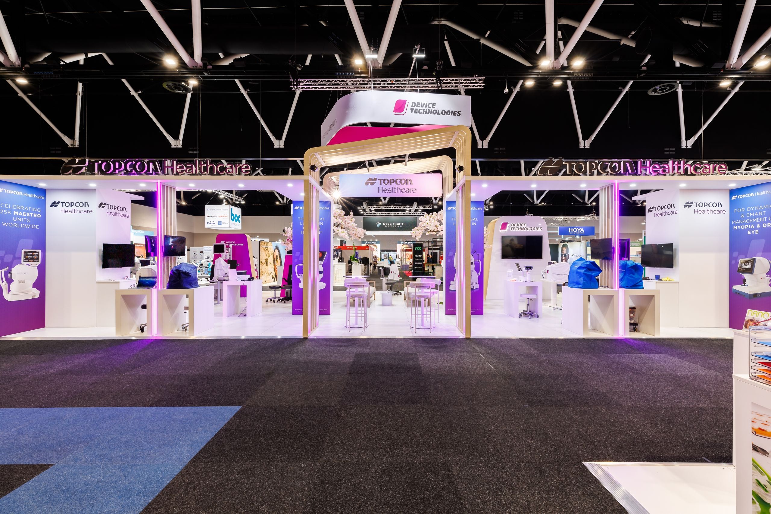 Exhibition stand featuring various electronic devices and branding. Custom built.