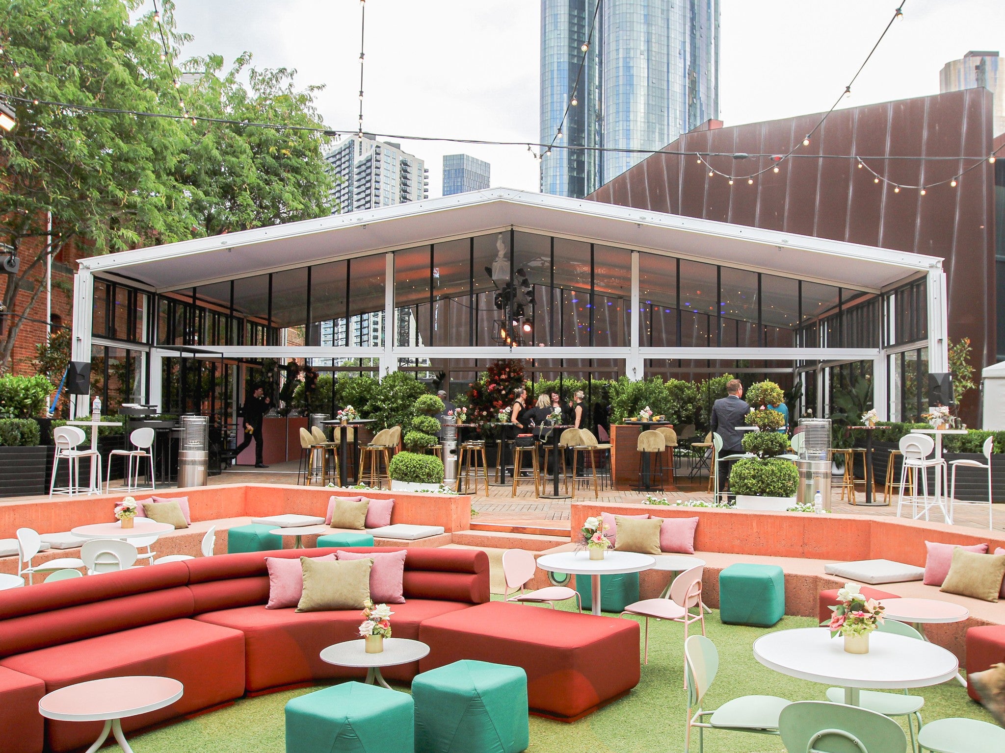 Outdoor seating area with colorful furniture outside our Alto Marquee