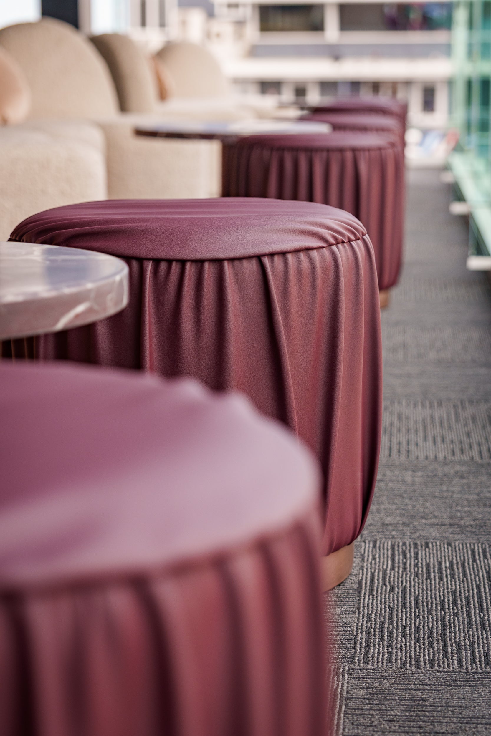 Rocco stools with pleated texture on a gray carpeted floor.