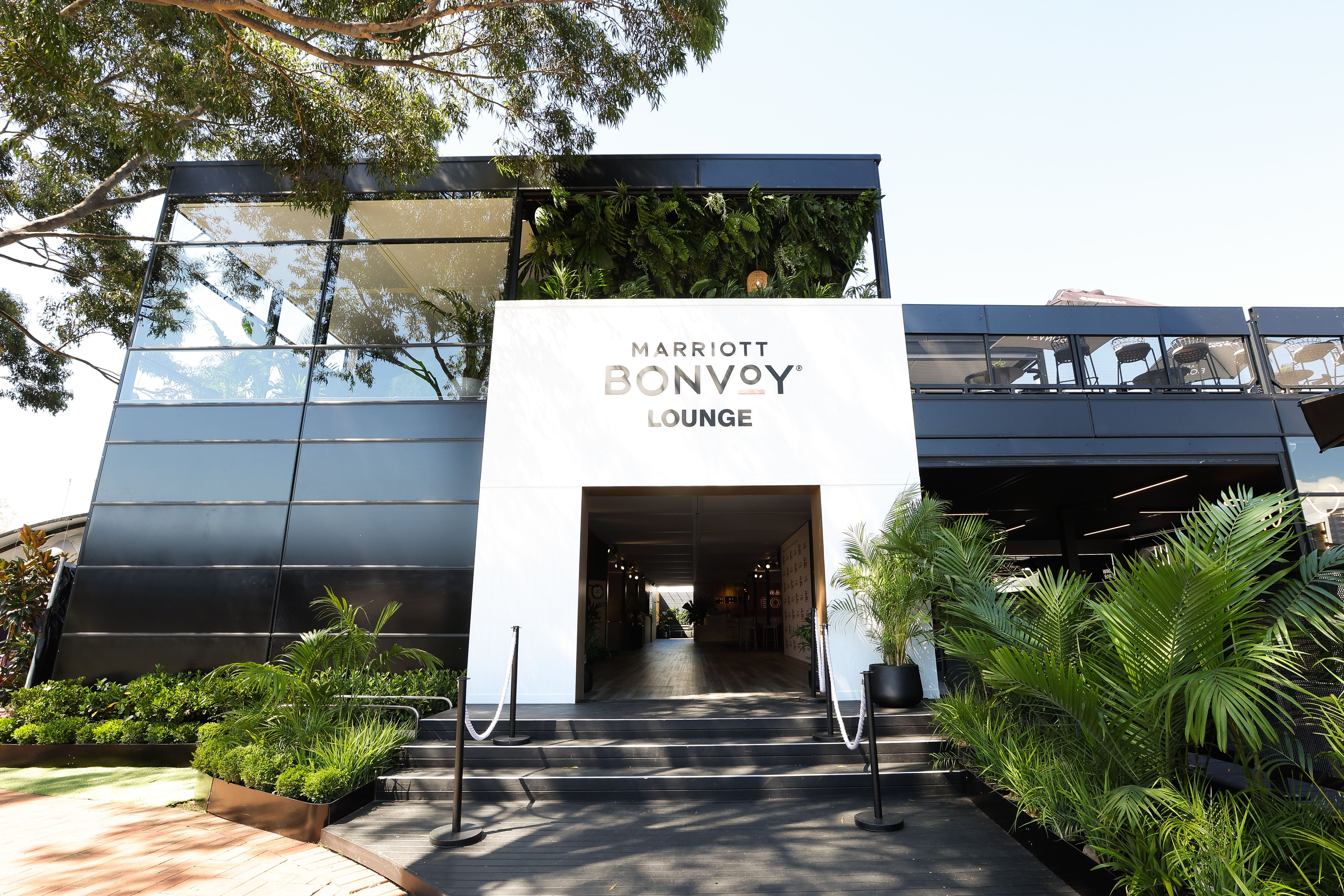 Marriott Bonvoy Lounge entrance with glass facade and greenery