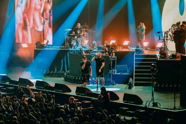 Live concert with performers on stage and audience in front