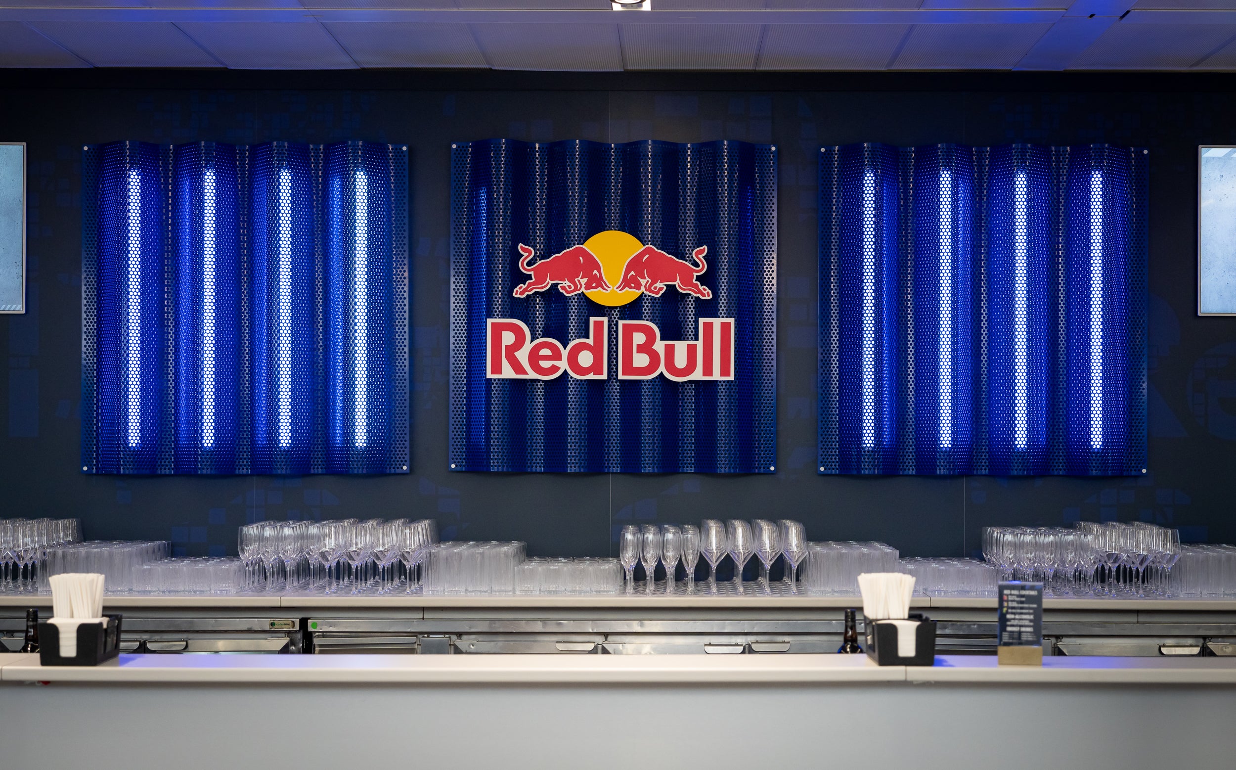Bar area with Red Bull logo on a dark wall