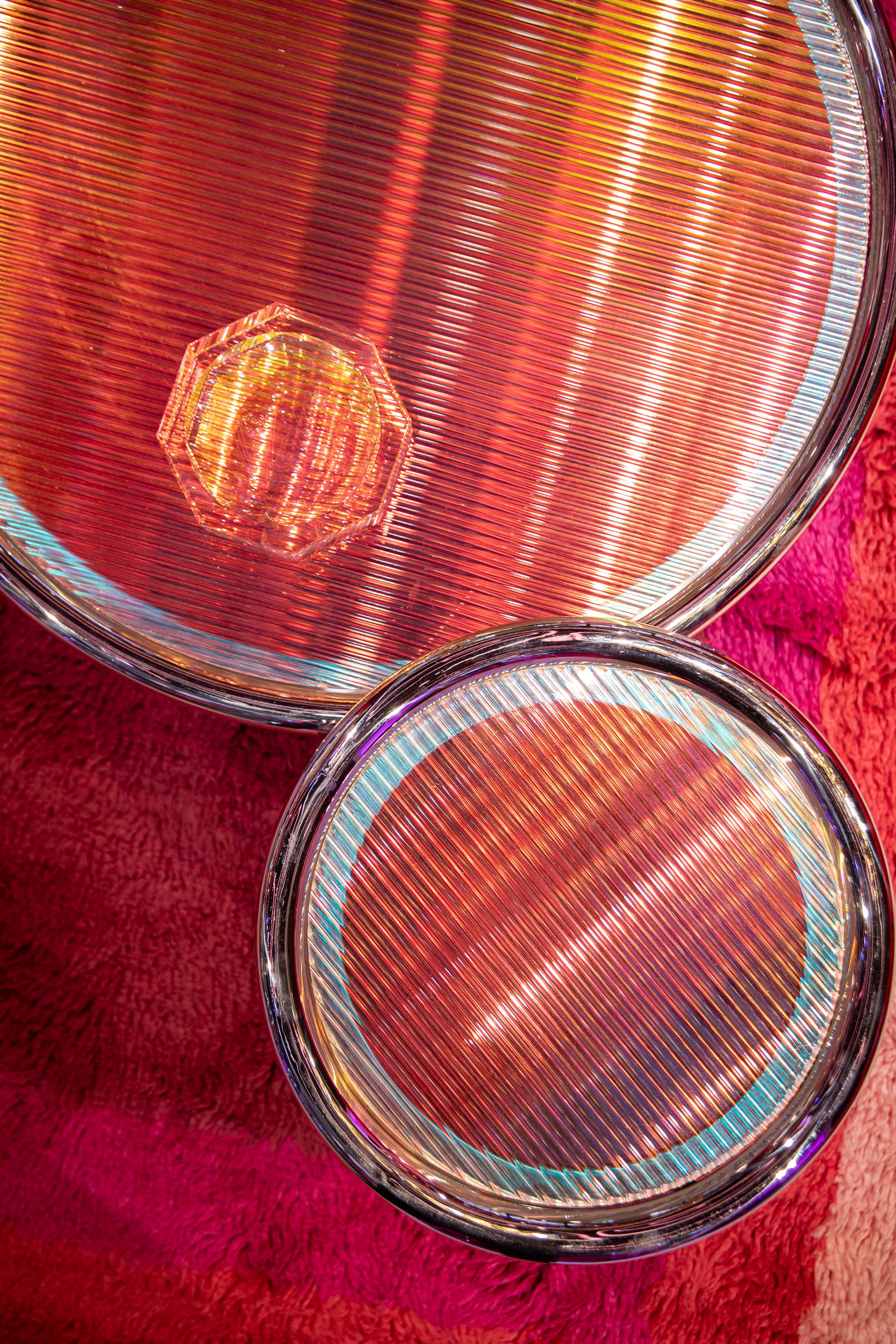 Close-up of two Helix Coffee Tables on a red fabric background