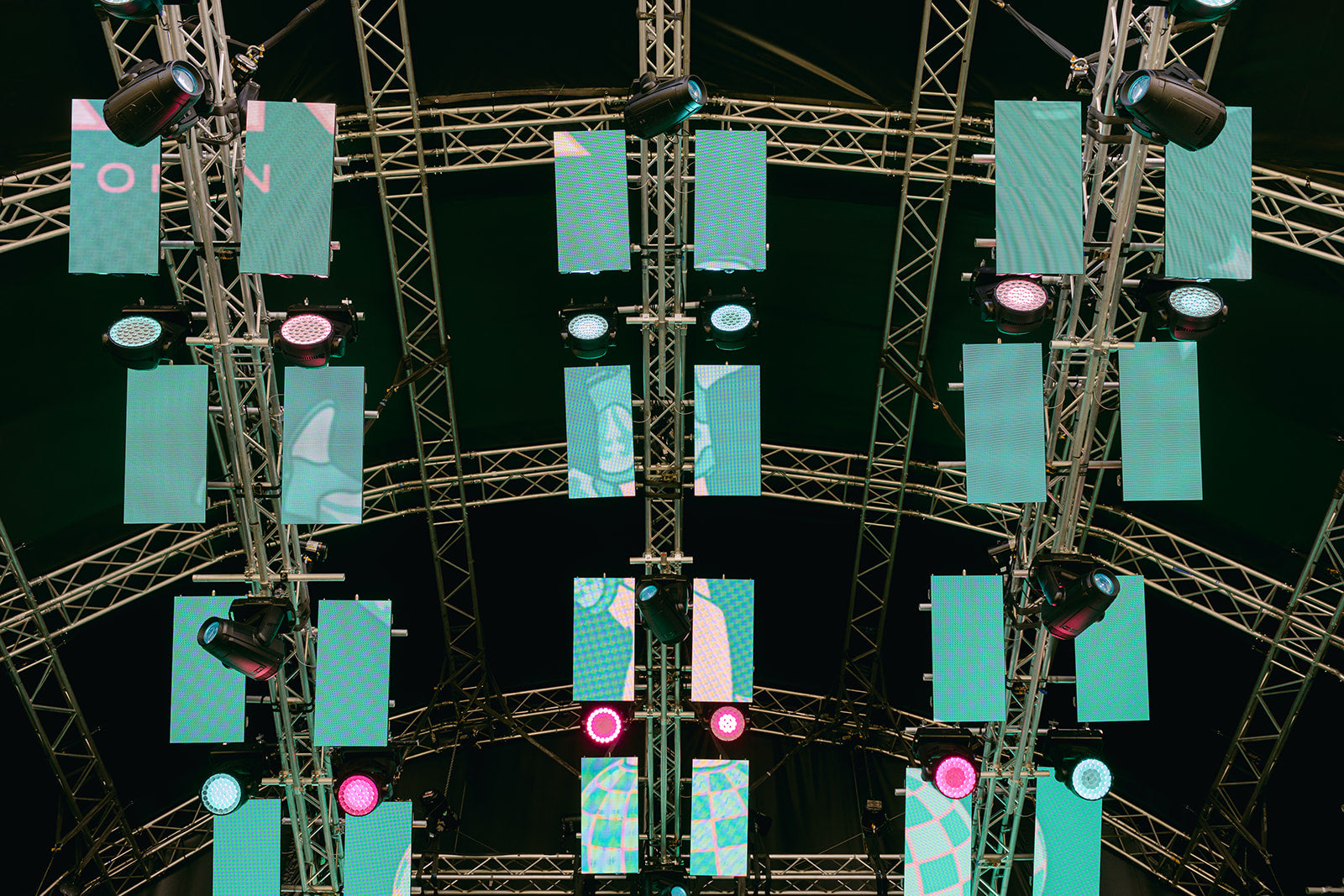 Screens rigged to a stage with various lighting