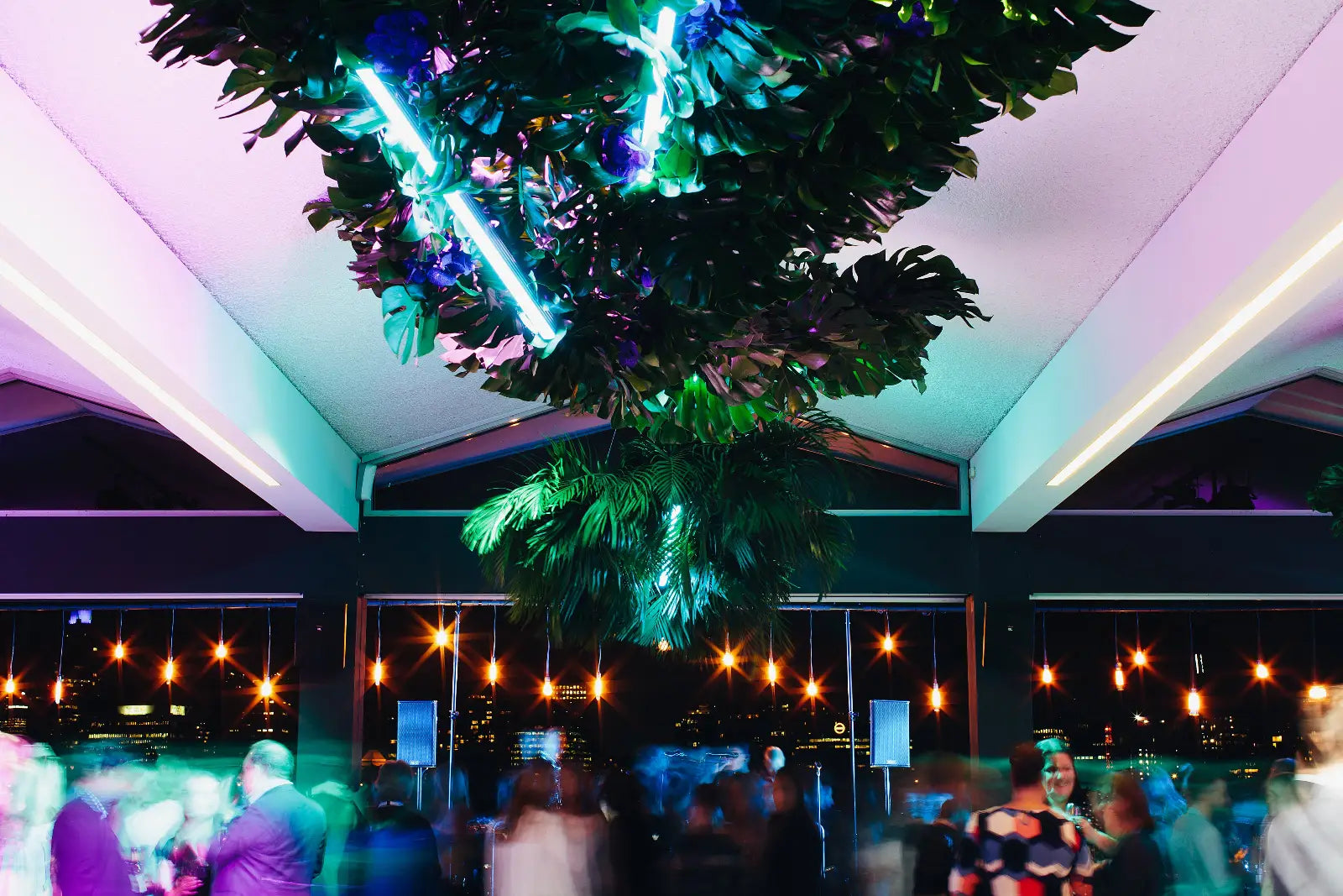 Decorative hanging plant with neon lights in a party setting