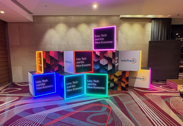 Colorful illuminated cubes with text on a patterned floor