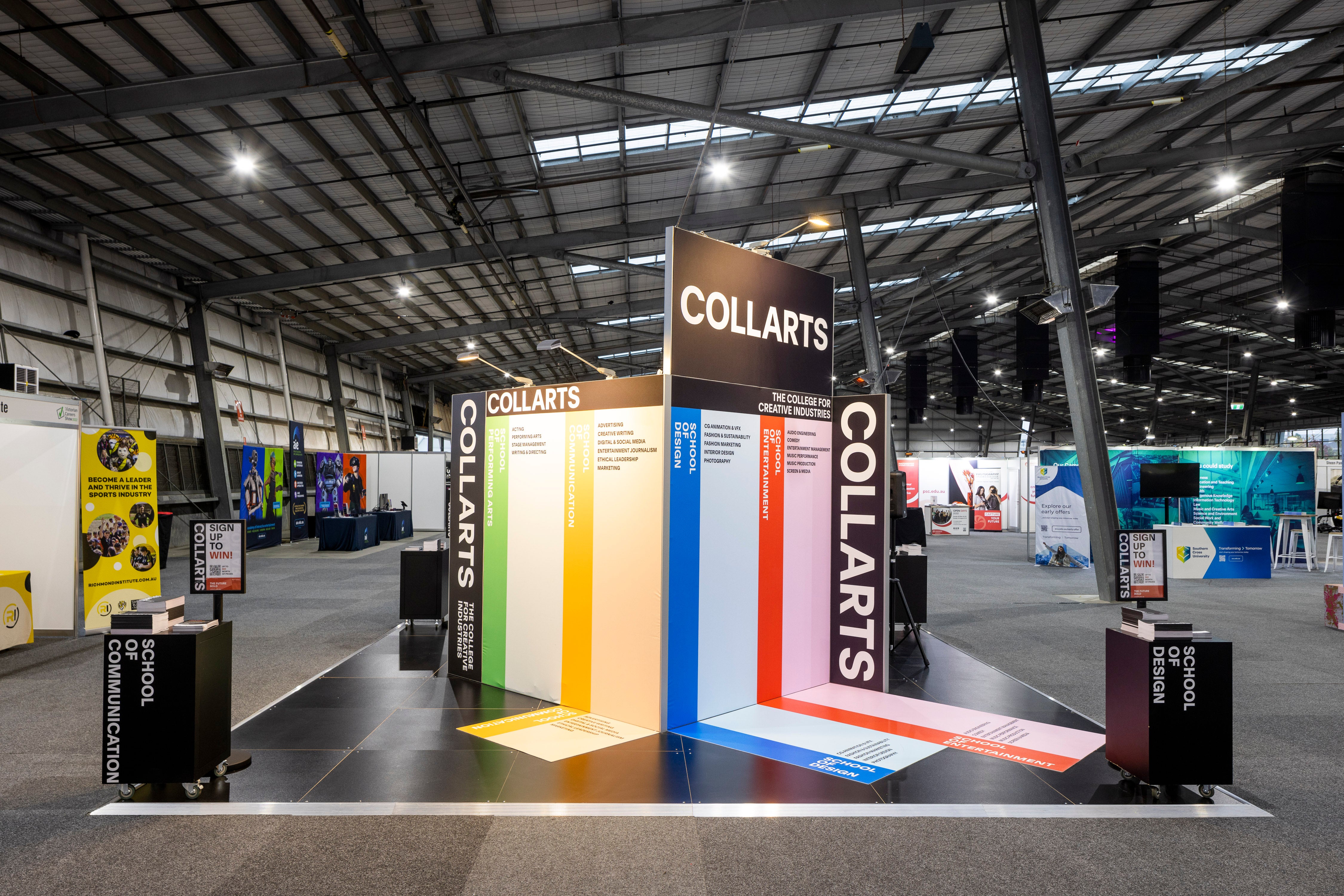 Collarts exhibition stand with colorful design in a large indoor event space.
