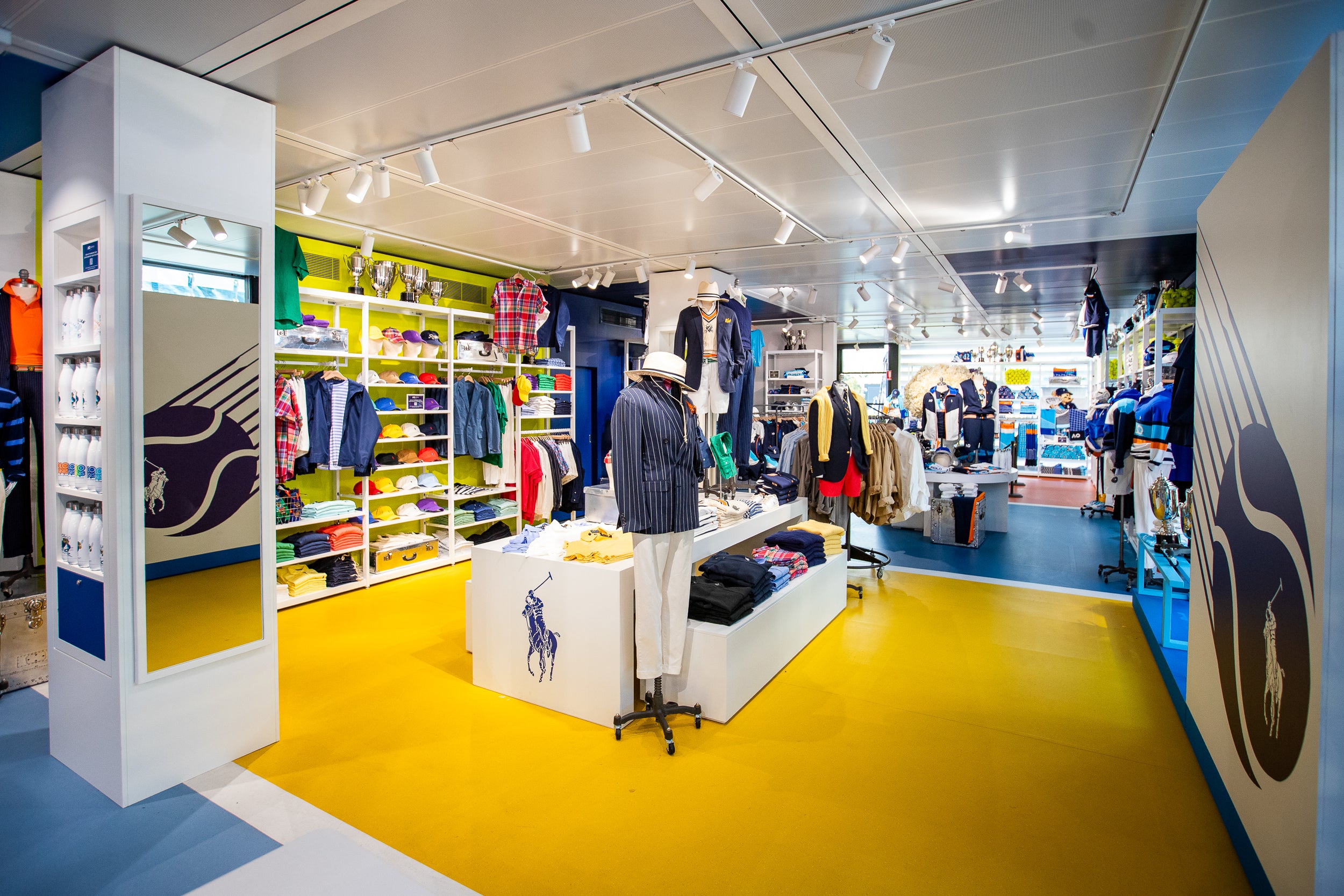 Interior of a clothing store with colorful displays and mannequins.