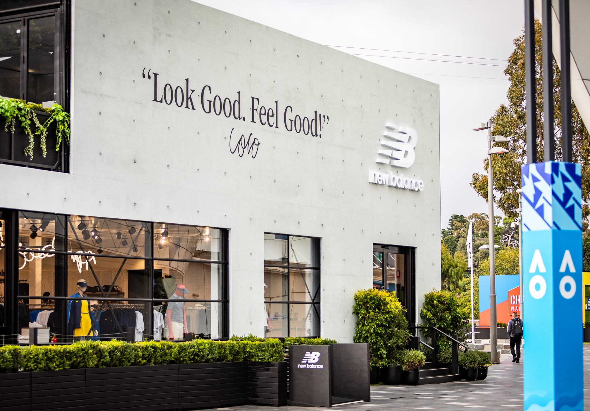 New Balance store exterior with branding and 'Look Good. Feel Good!' slogan.