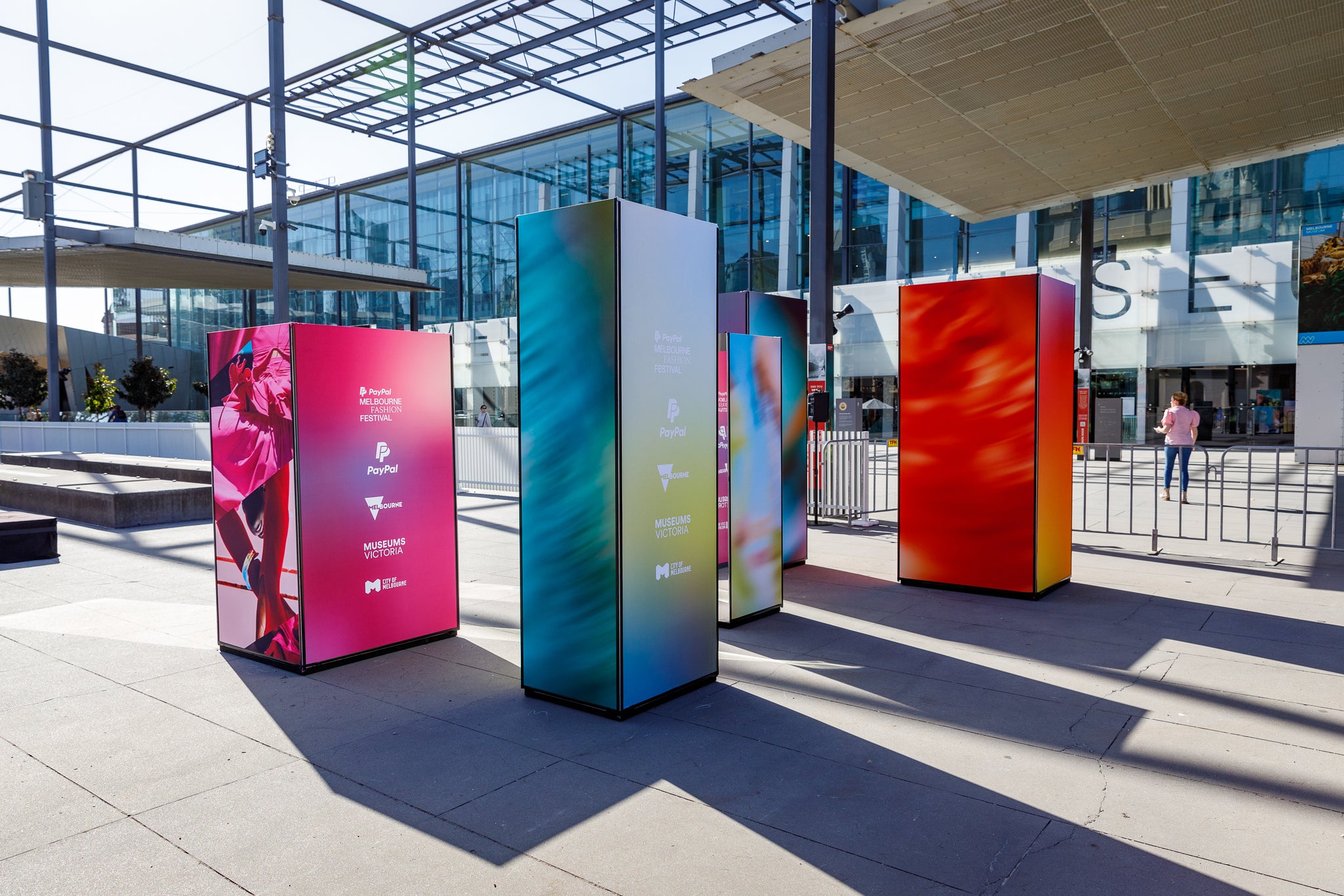 Colorful wayfinding display stands in front of the Melbourne Museum for Melbourne Fashion Festival