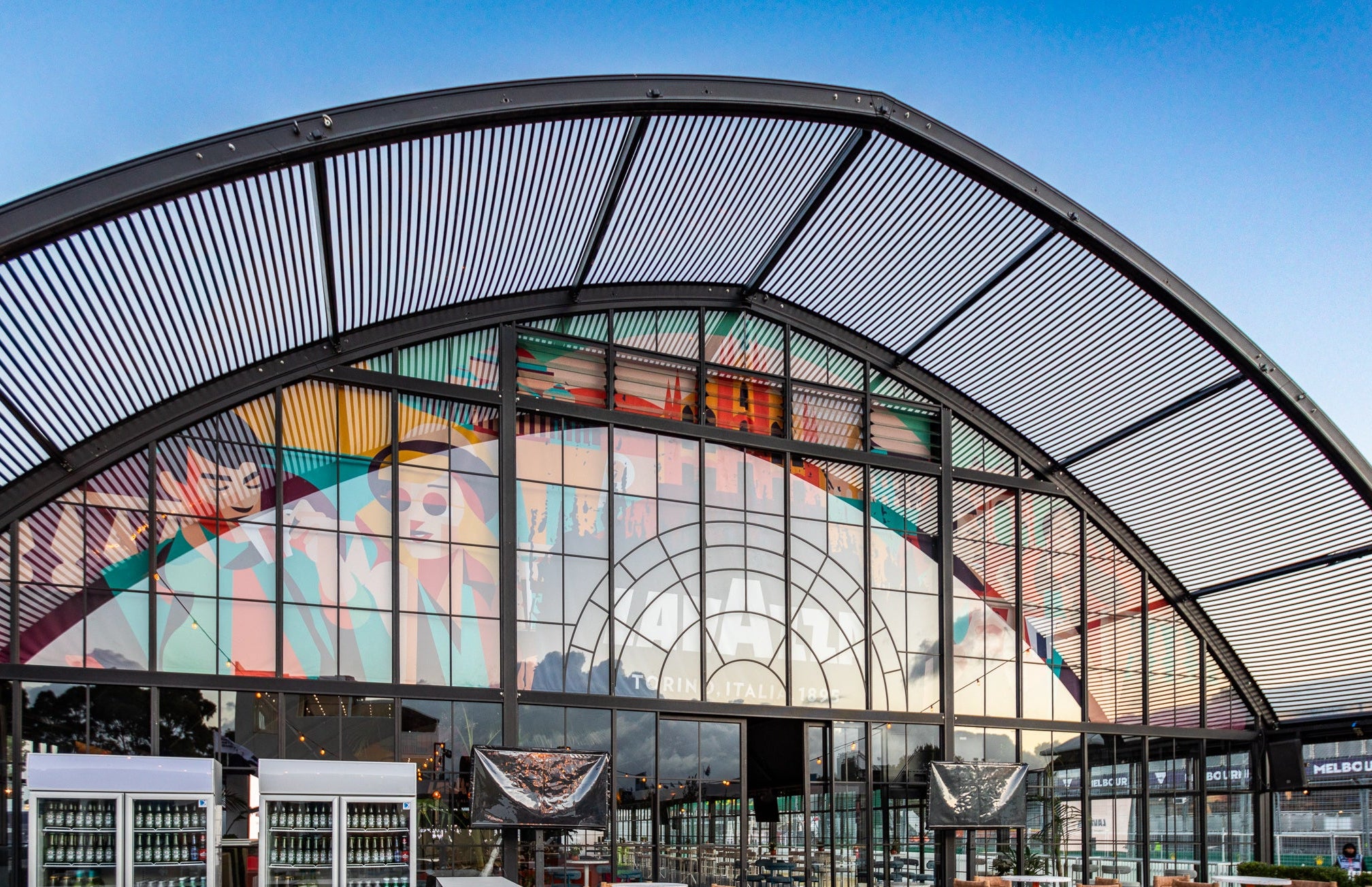 Atrium marquee with large glass facade and outdoor seating area.