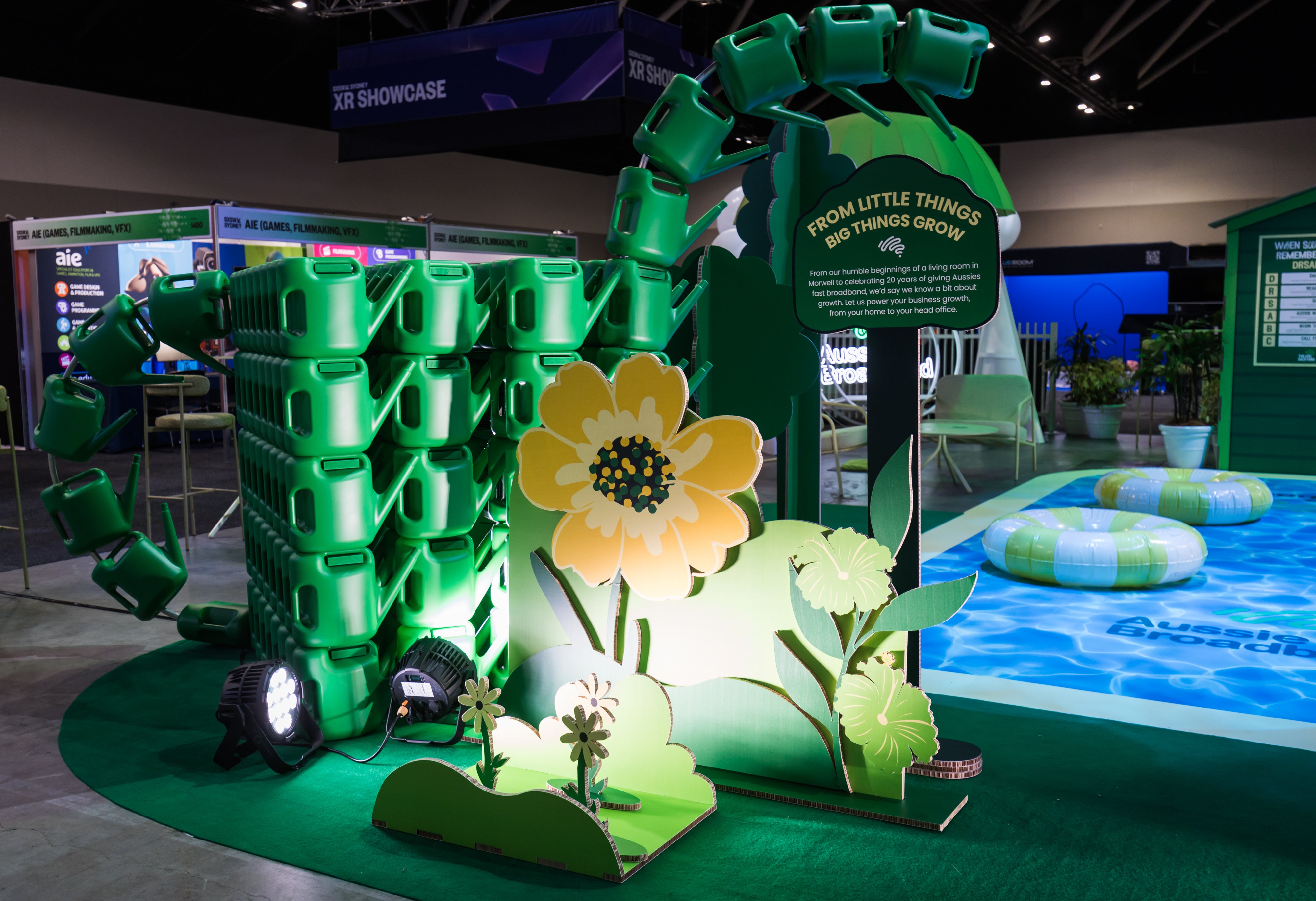 Expo signage made from watering cans and cardboard