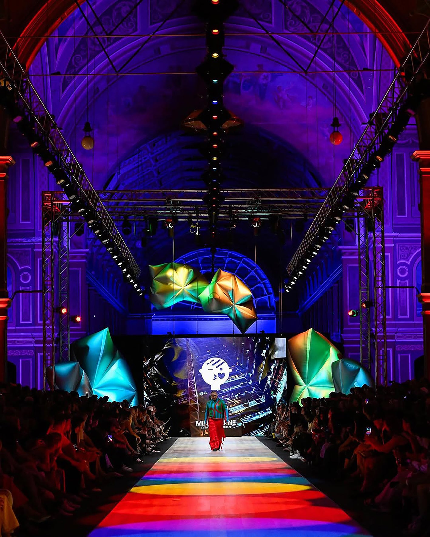 Fashion show with colorful runway and vibrant lighting