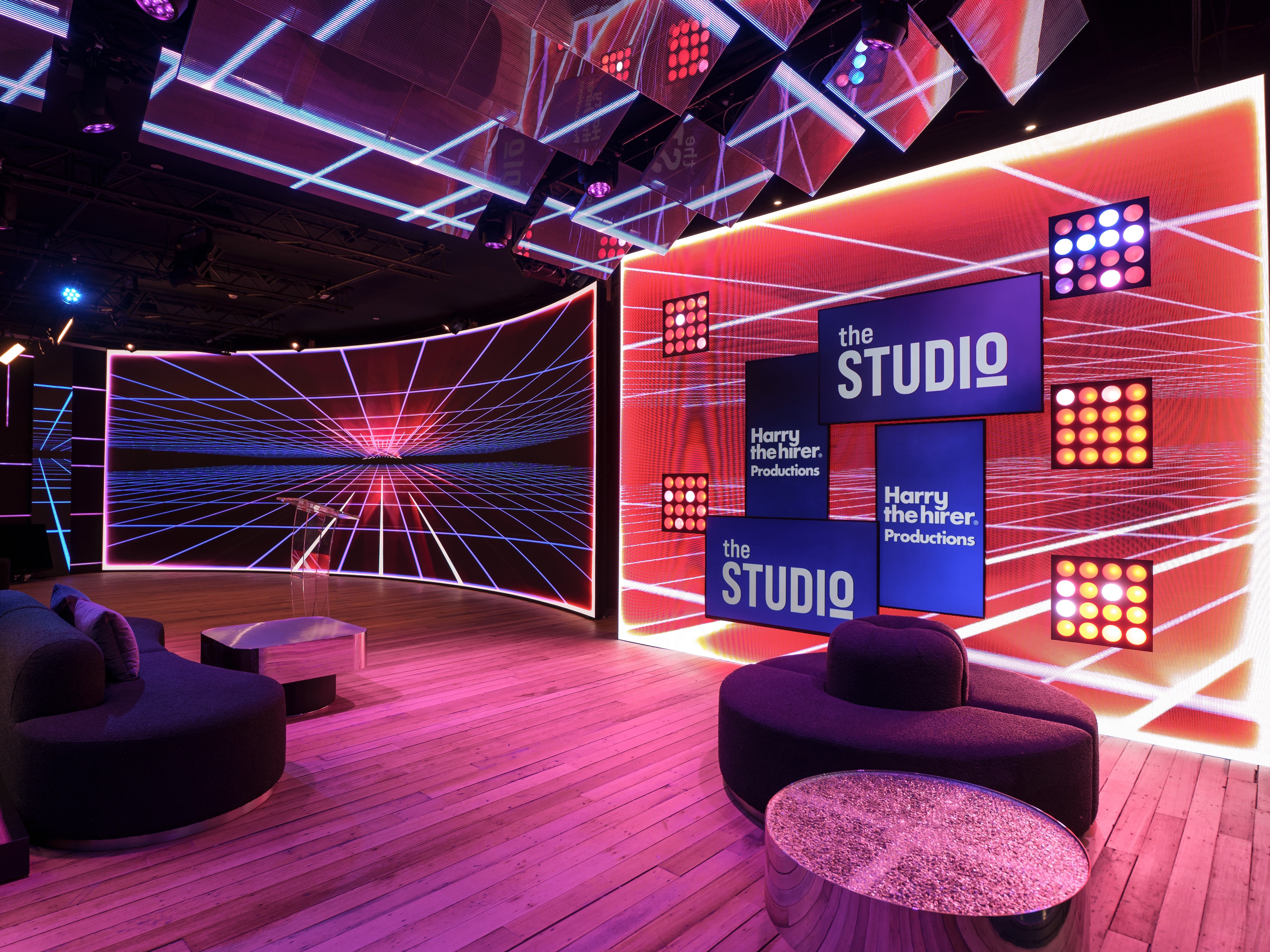 Modern studio interior with 'the STUDIO' branding and colorful lighting.