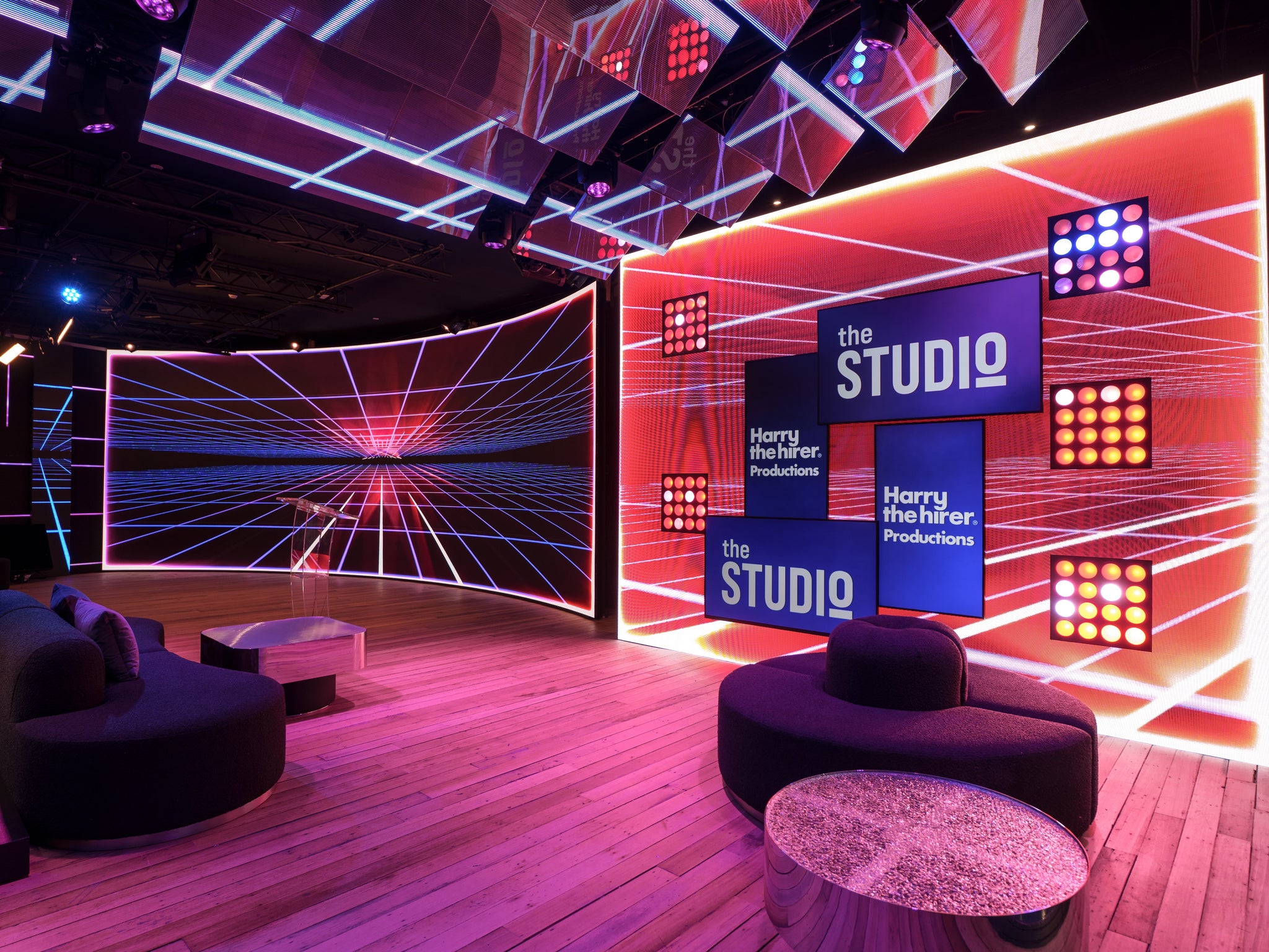 Modern studio interior with 'the STUDIO' branding and colorful lighting.