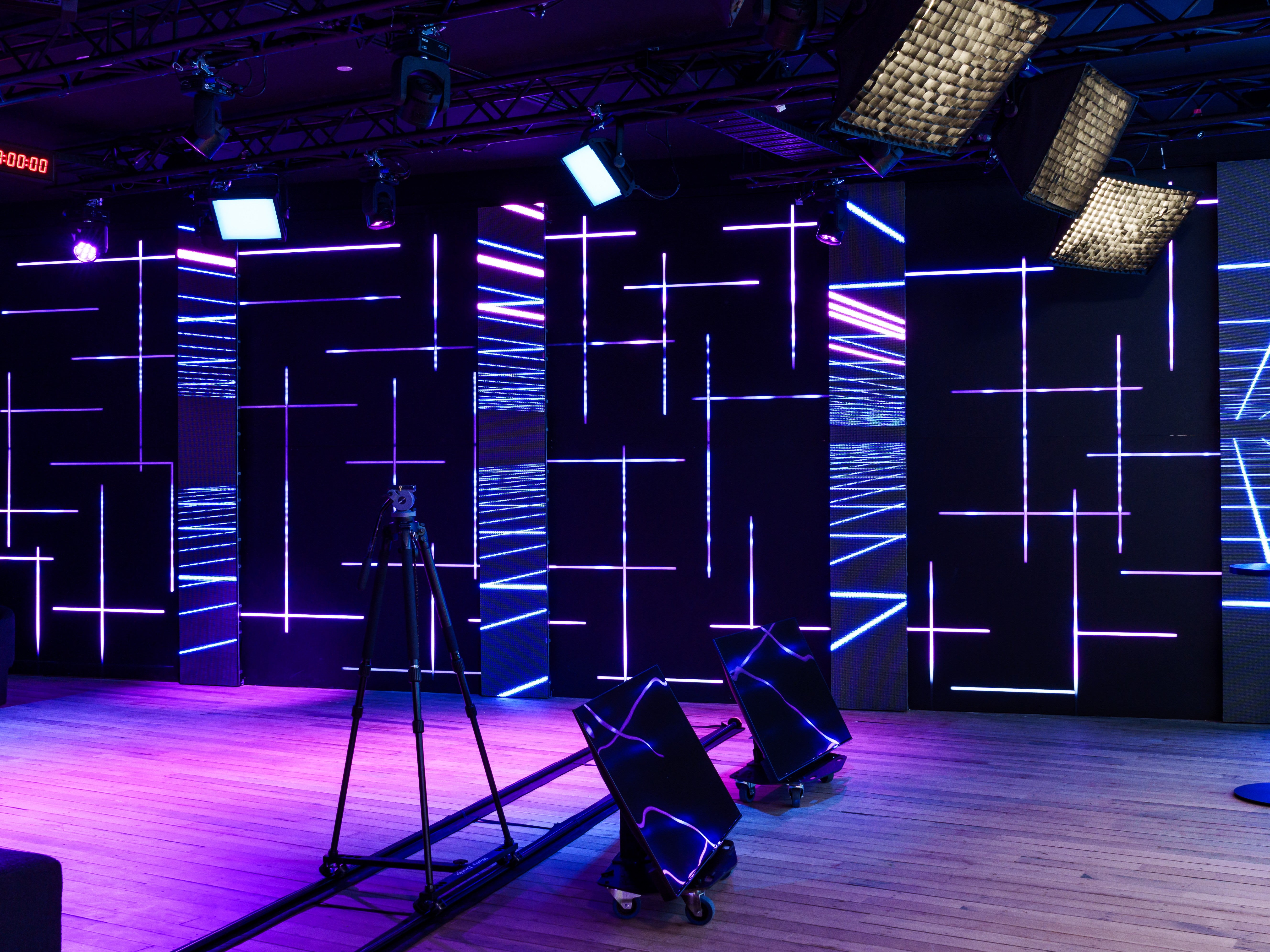 Modern stage design with geometric light patterns on a dark background