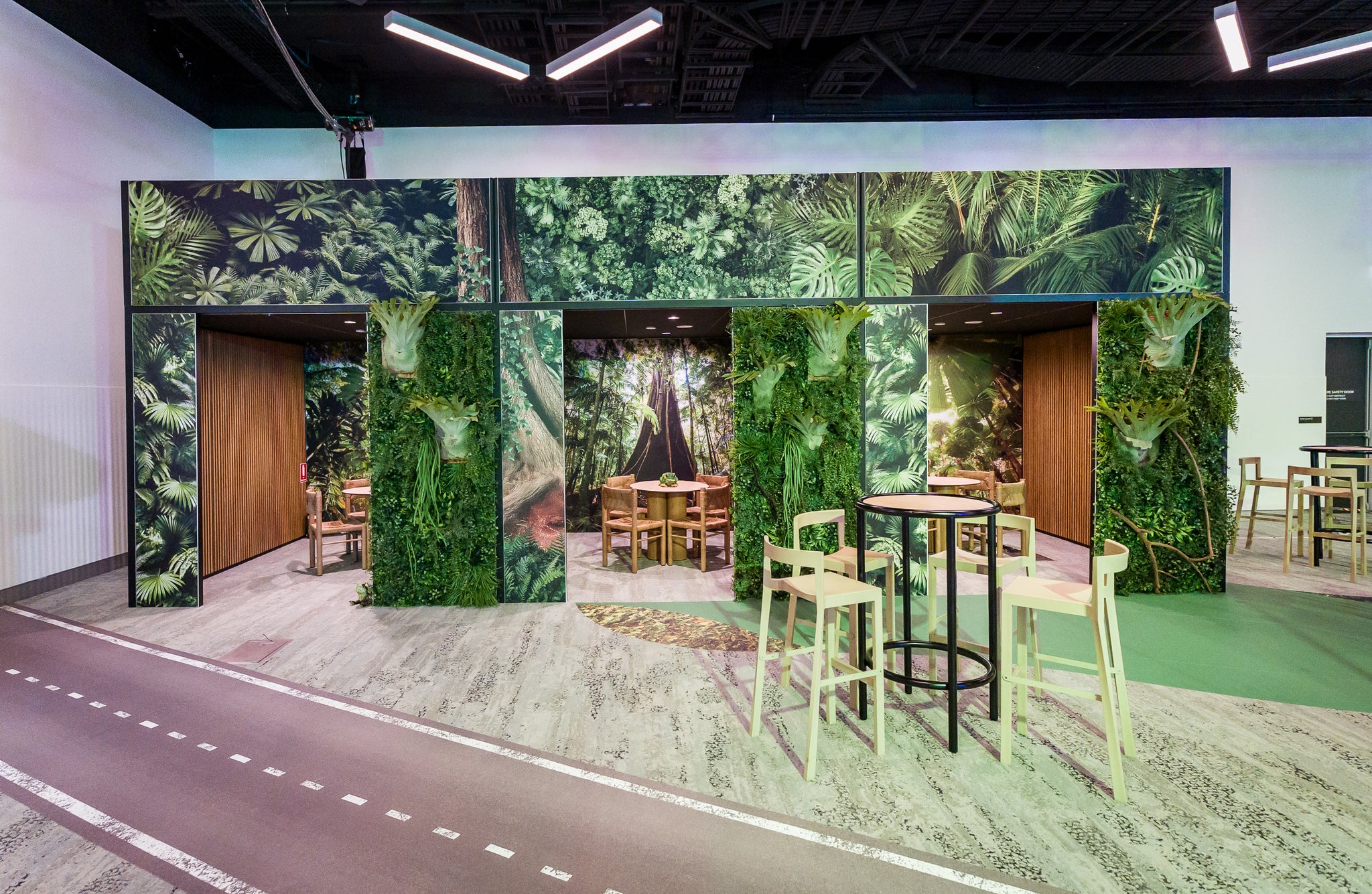 Modern expo stand design with greenery-themed walls and furniture. Shot at YPO in Sydney
