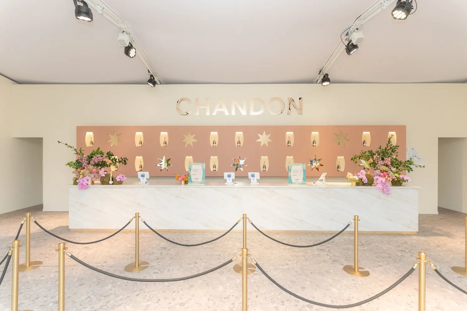 Chandom marquee at Aus GP with custom bar, backdrop and gold accents