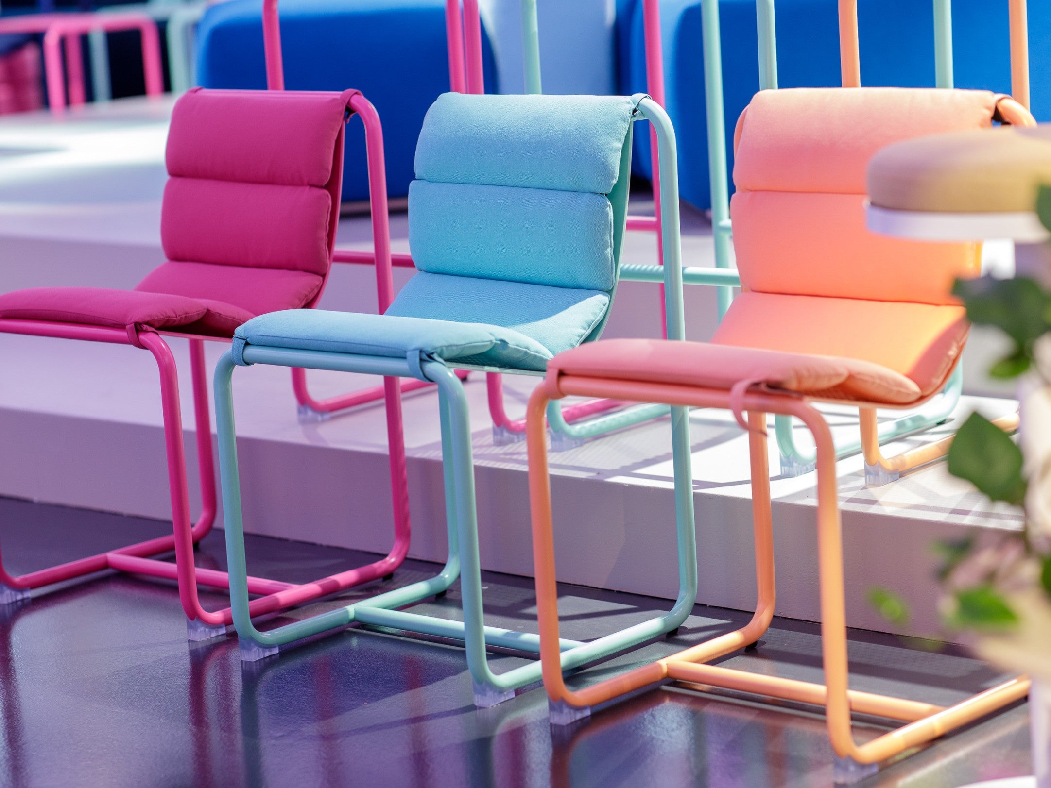 Assortment of brightly coloured Isla chairs and stools in pastel and primary tones in our Melbourne Showroom