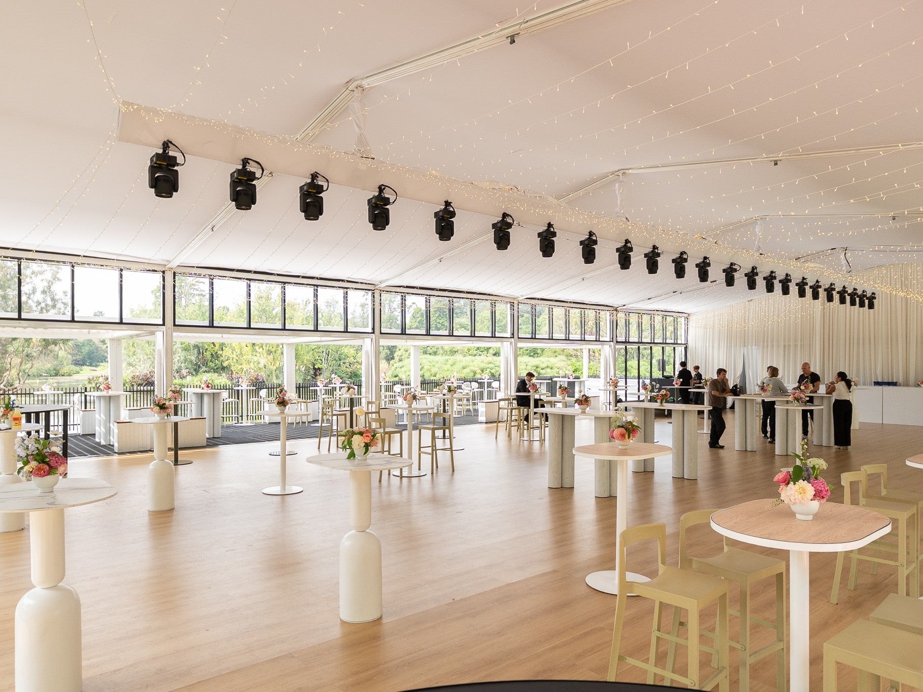 Interior shot of our Alto Marquee space with tables and chairs arranged for a gathering.