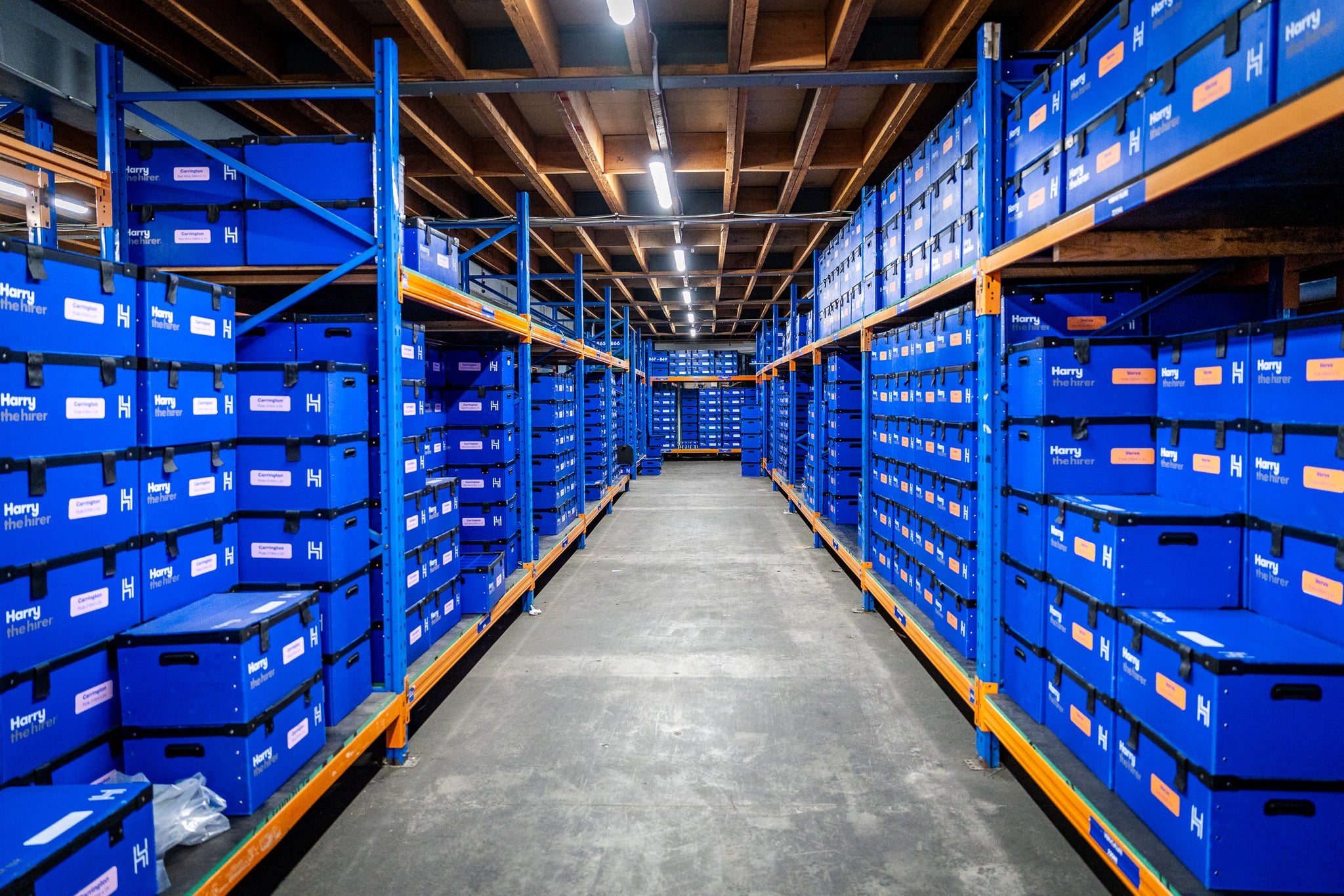 Harry The Hirer Warehouse with blue storage boxes stacked on shelves