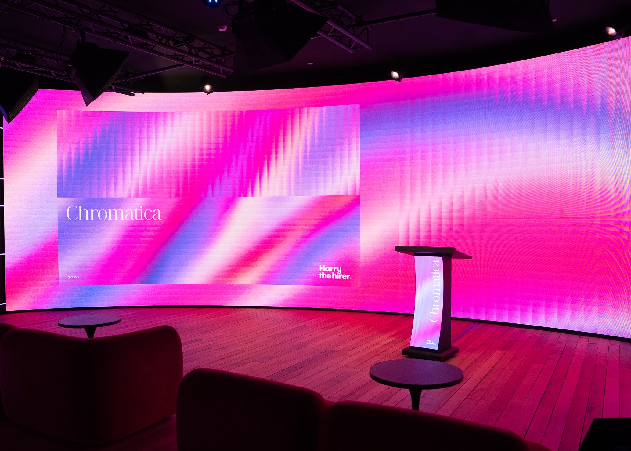 Modern interior with a large curved digital display wall featuring colorful abstract patterns.