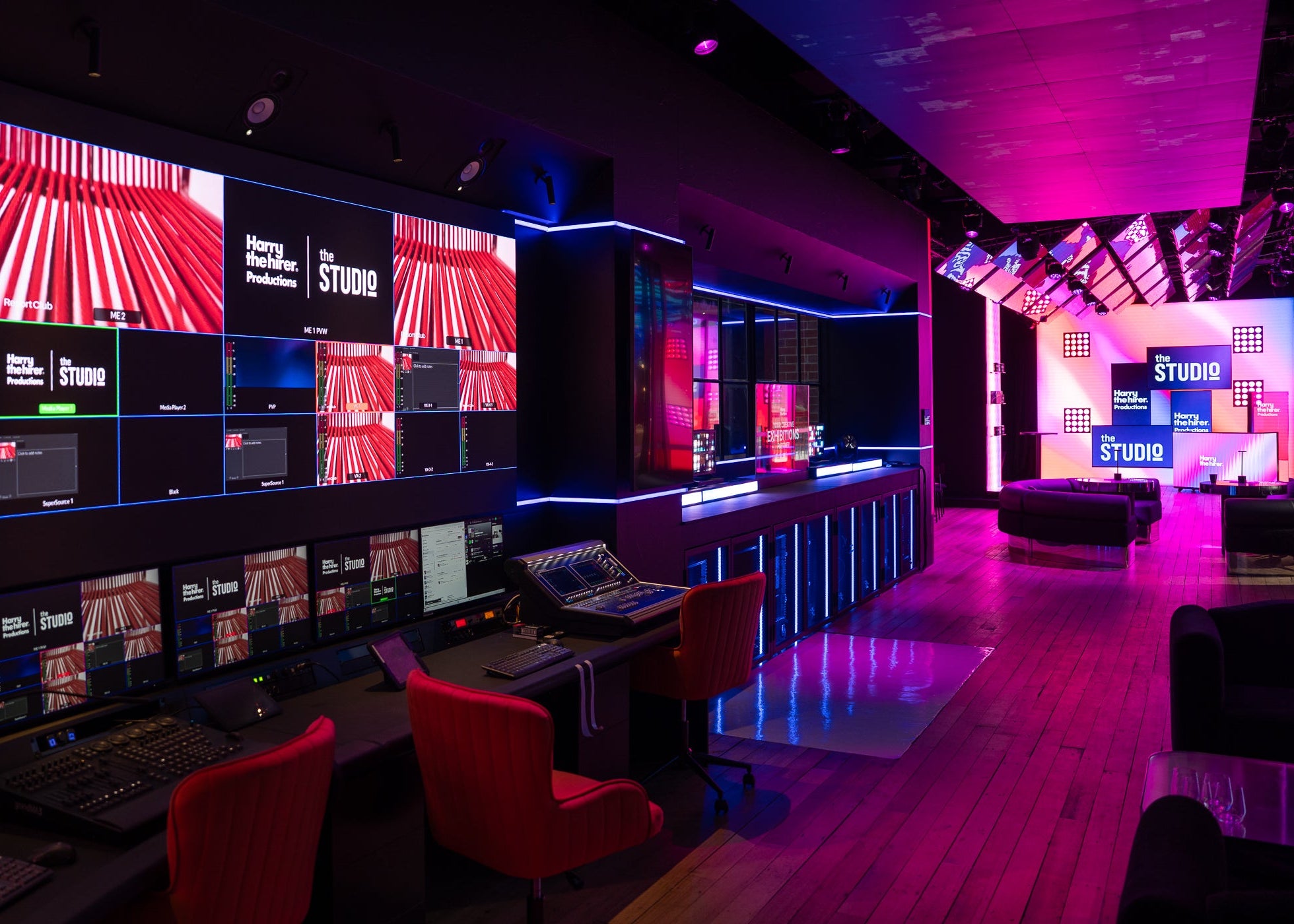 Control room with multiple monitors and a stage area in a studio setting.