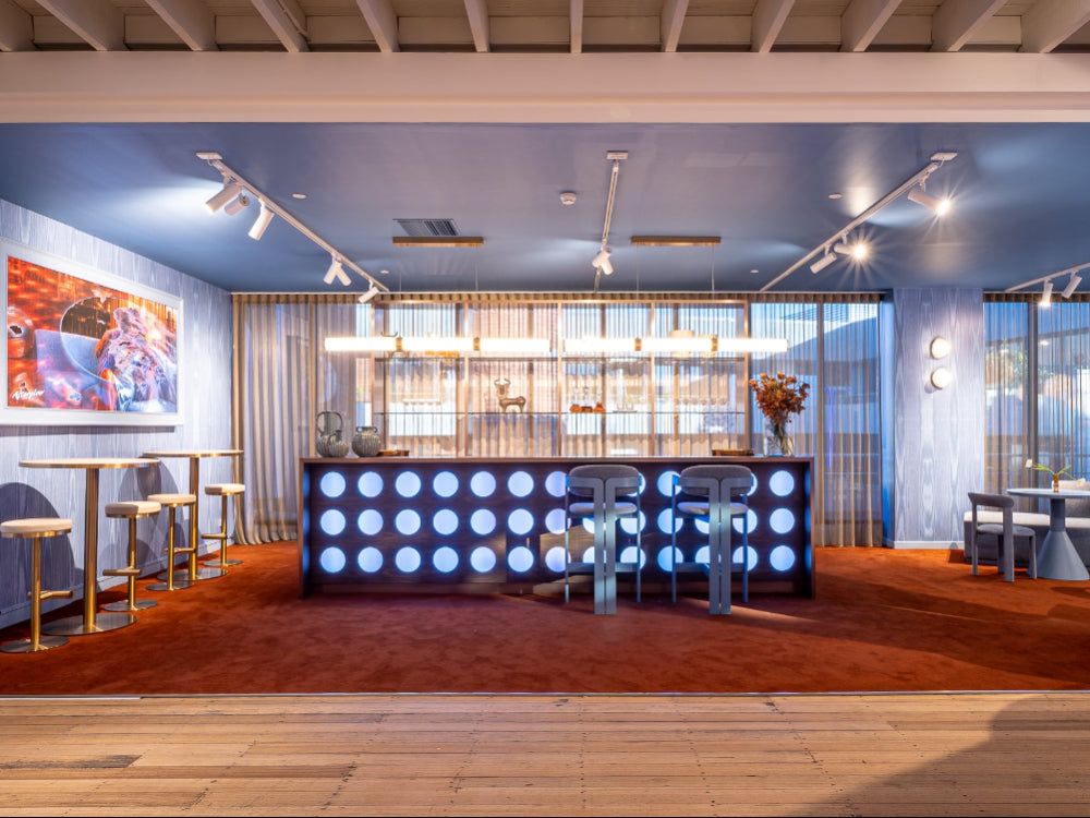 Modern interior design with a bar area, seating, and decorative elements.