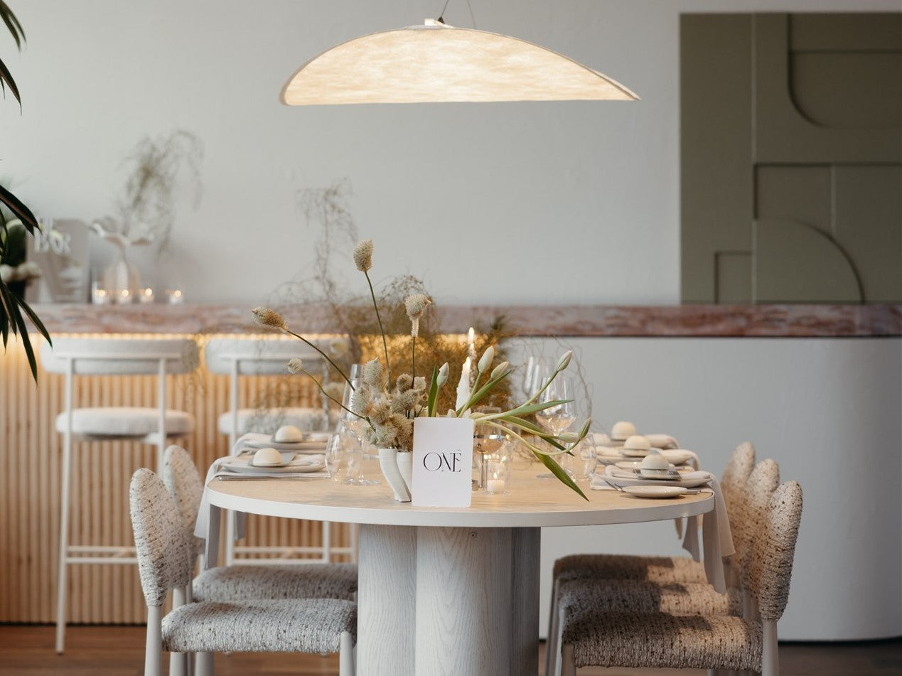 Dining area with a vase with flowers and candles.