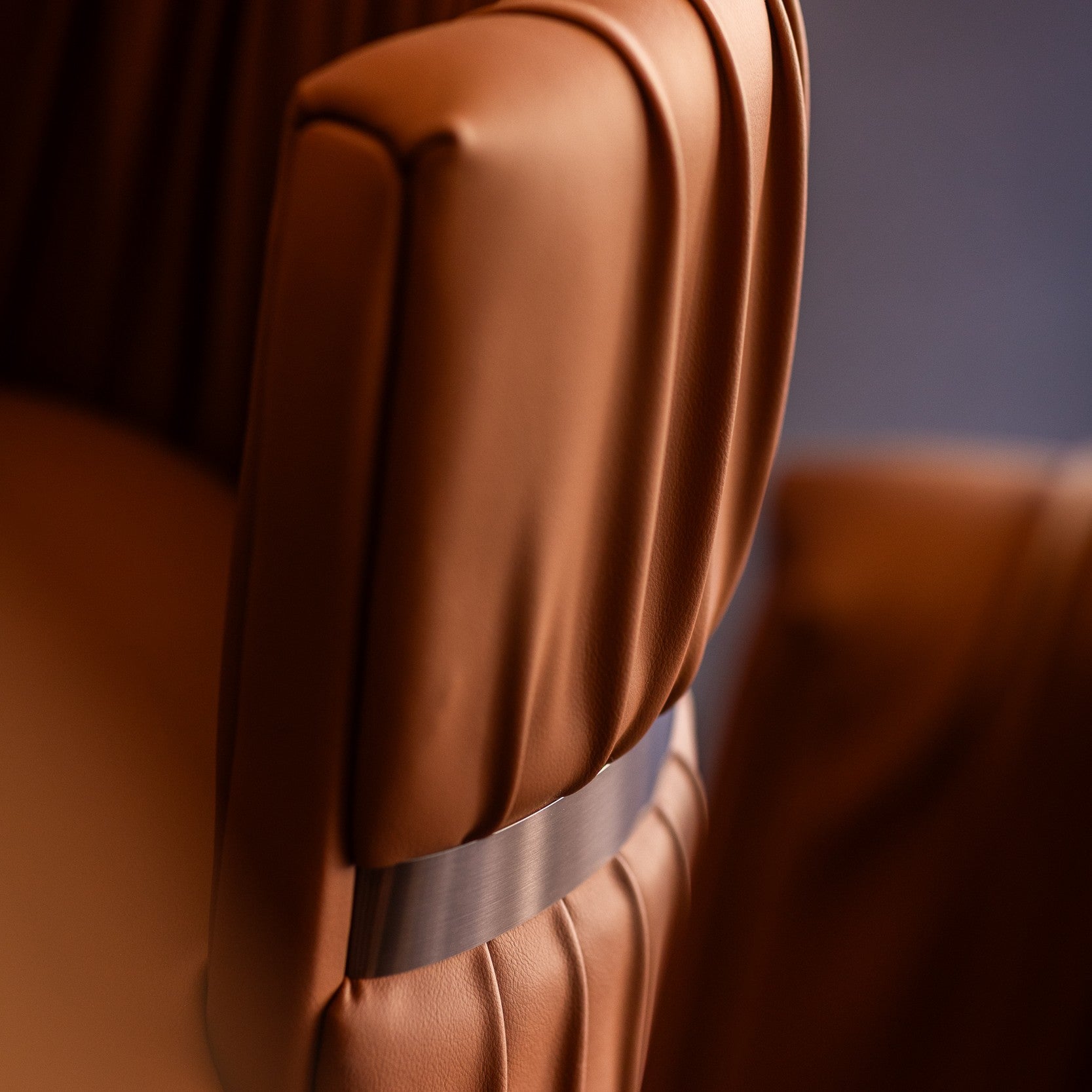 Close-up of a brown leather Rocco seat with a visible stitching detail.