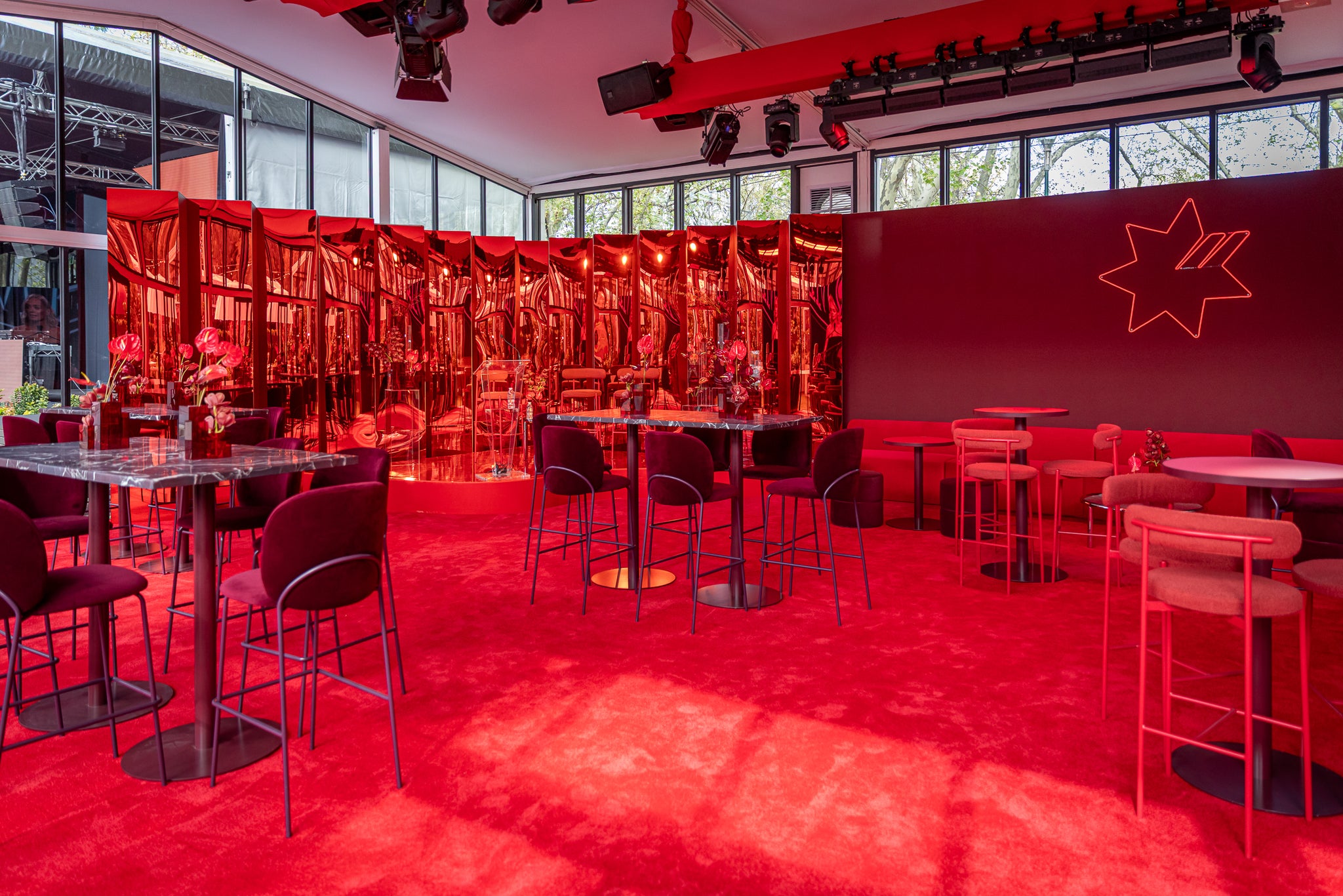 Marquee at AFL Grand Final with a red interior, with custom signage, hire furniture and lighting and rigging.