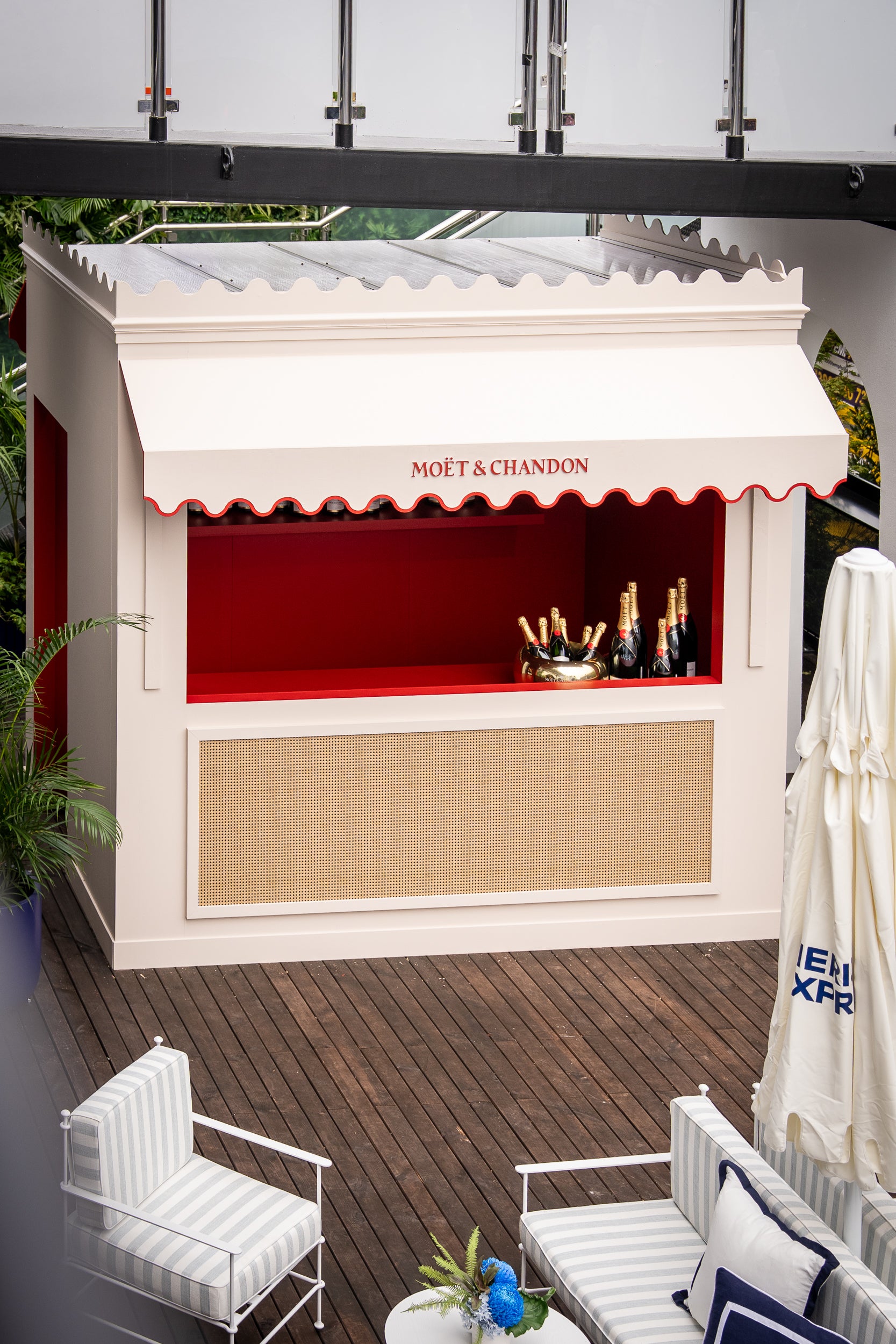 Outdoor bar with Moët & Chandon branding on a wooden deck.